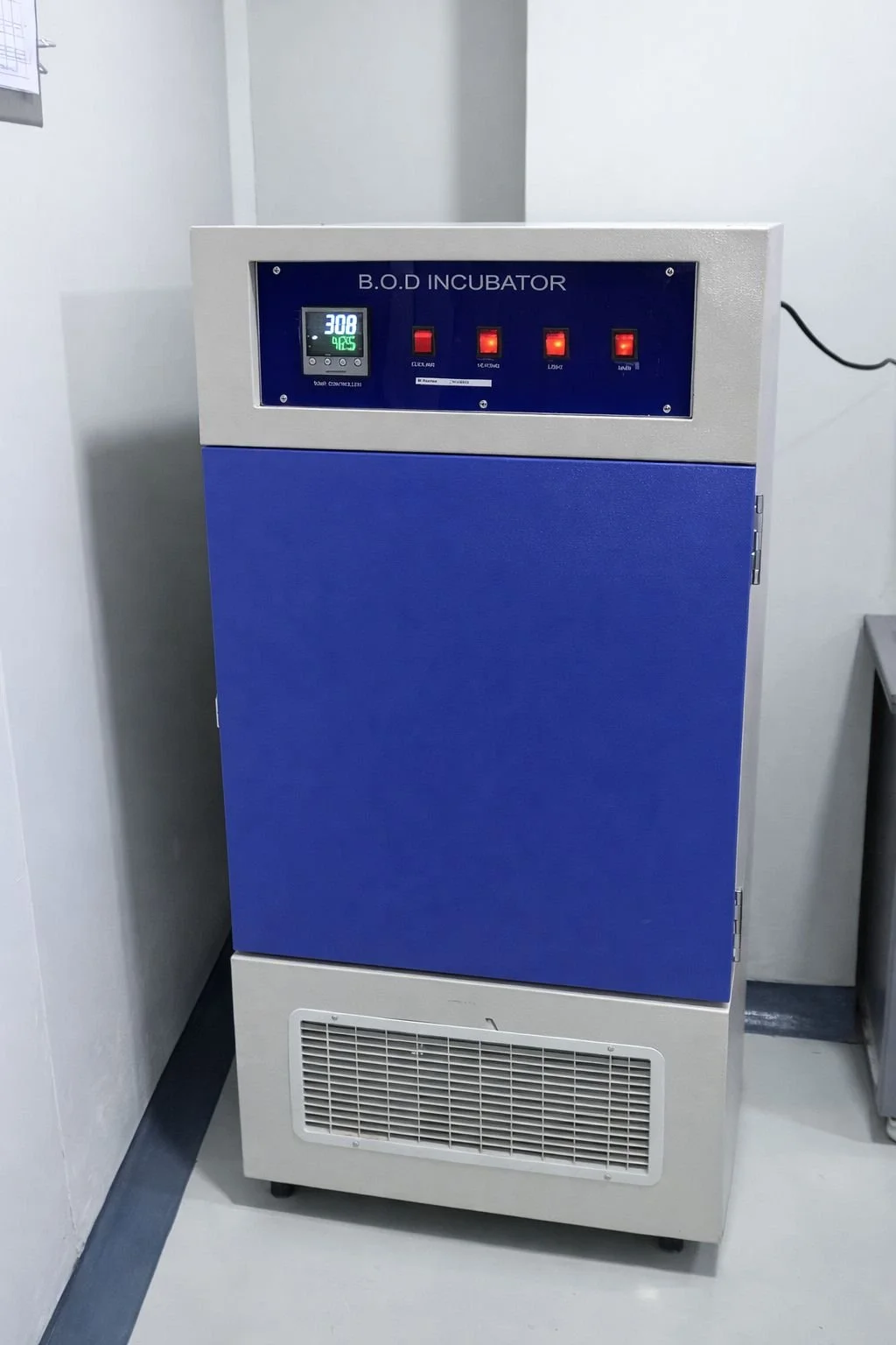 A laboratory B.O.D incubator with a digital display showing 308 ppm, and four red indicator lights labeled Clock, Vortex, Light, and Alarm.