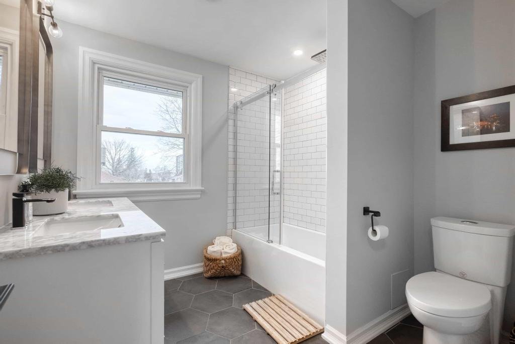 Ottawa bathroom renovation with a custom vanity, updated fixtures, and affordable luxury finishes by Centennial Construction Management, a trusted renovation contractor. In this project a pre-fab option was used to help client with costs