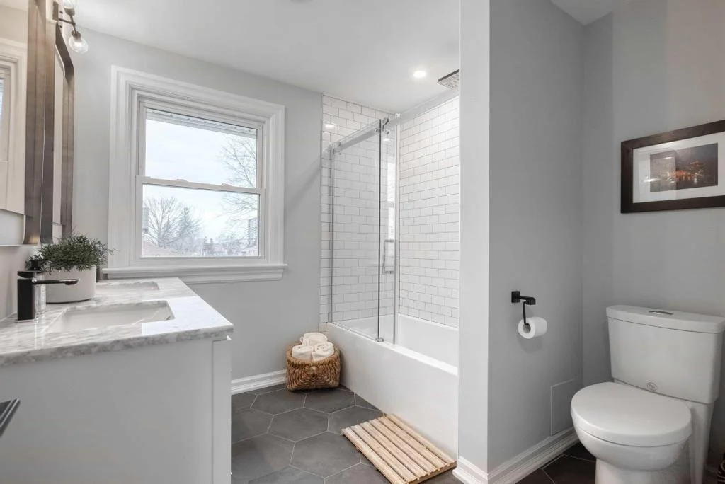 Ottawa bathroom renovation featuring tub and glass shower with modern finishes Contemporary bathroom in Ottawa with tub shower combination and updated design Newly renovated bathroom in Ottawa with modern tub, shower, and sleek finishes