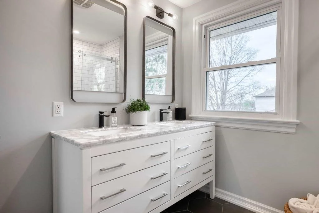 Ottawa bathroom renovation featuring a prefab vanity elevated with designer mirrors and beautiful tile work, blending affordability with a refined, high-end look by Centennial Construction Management.