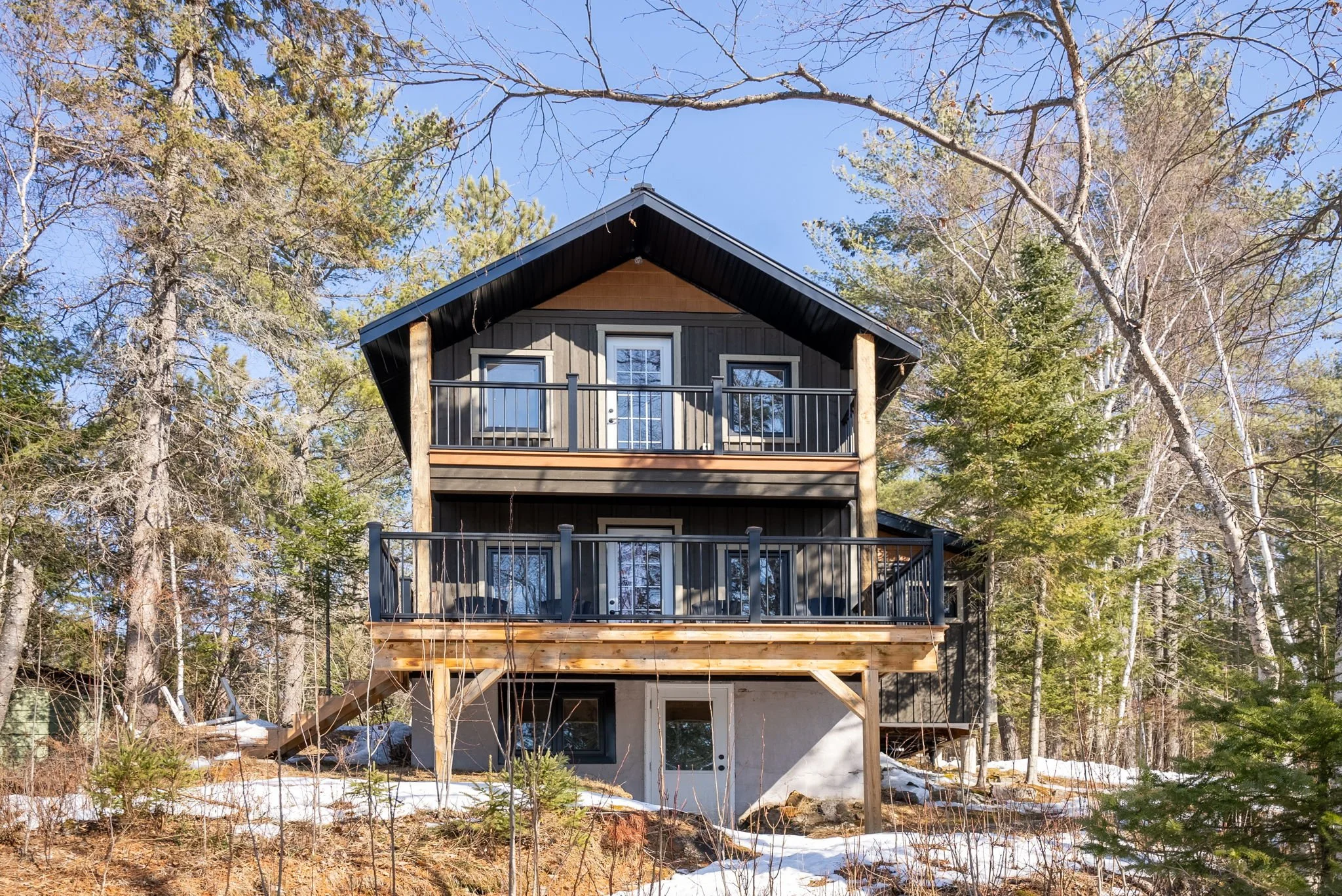A thoughtfully designed bunkie cottage, blending compact living with warm materials and refined craftsmanship for a cozy retreat experience