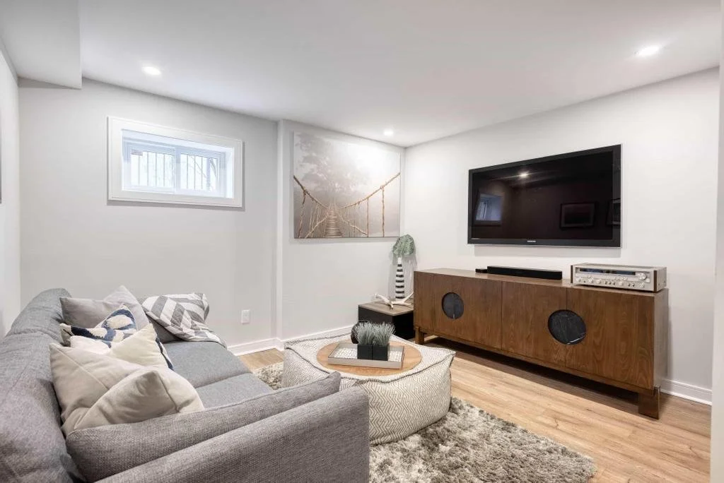 A thoughtfully designed basement TV space in McKellar Park, created to maximize every square foot while delivering a cozy, inviting atmosphere.