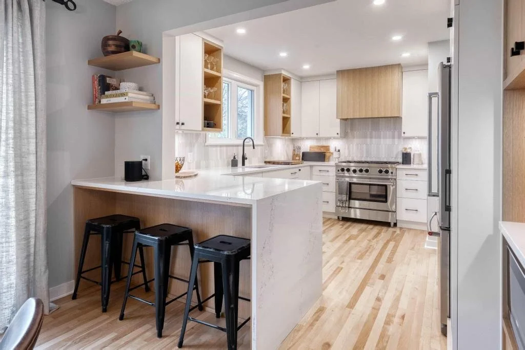 Ottawa kitchen renovation in Glabar Park transforming an original 1940s home with a sleek modern design, BlueStar appliances, and custom millwork by Centennial Construction Management.