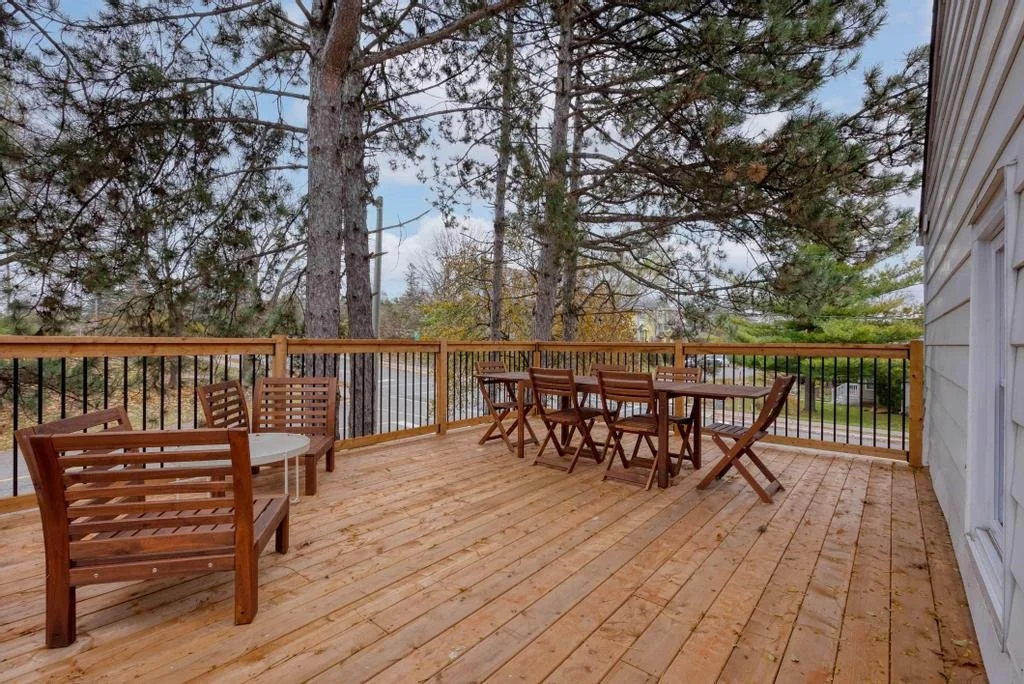 Custom outdoor living space in Ottawa featuring a spacious wood deck, integrated seating, and seamless indoor-outdoor flow, built by Centennial Construction Management.