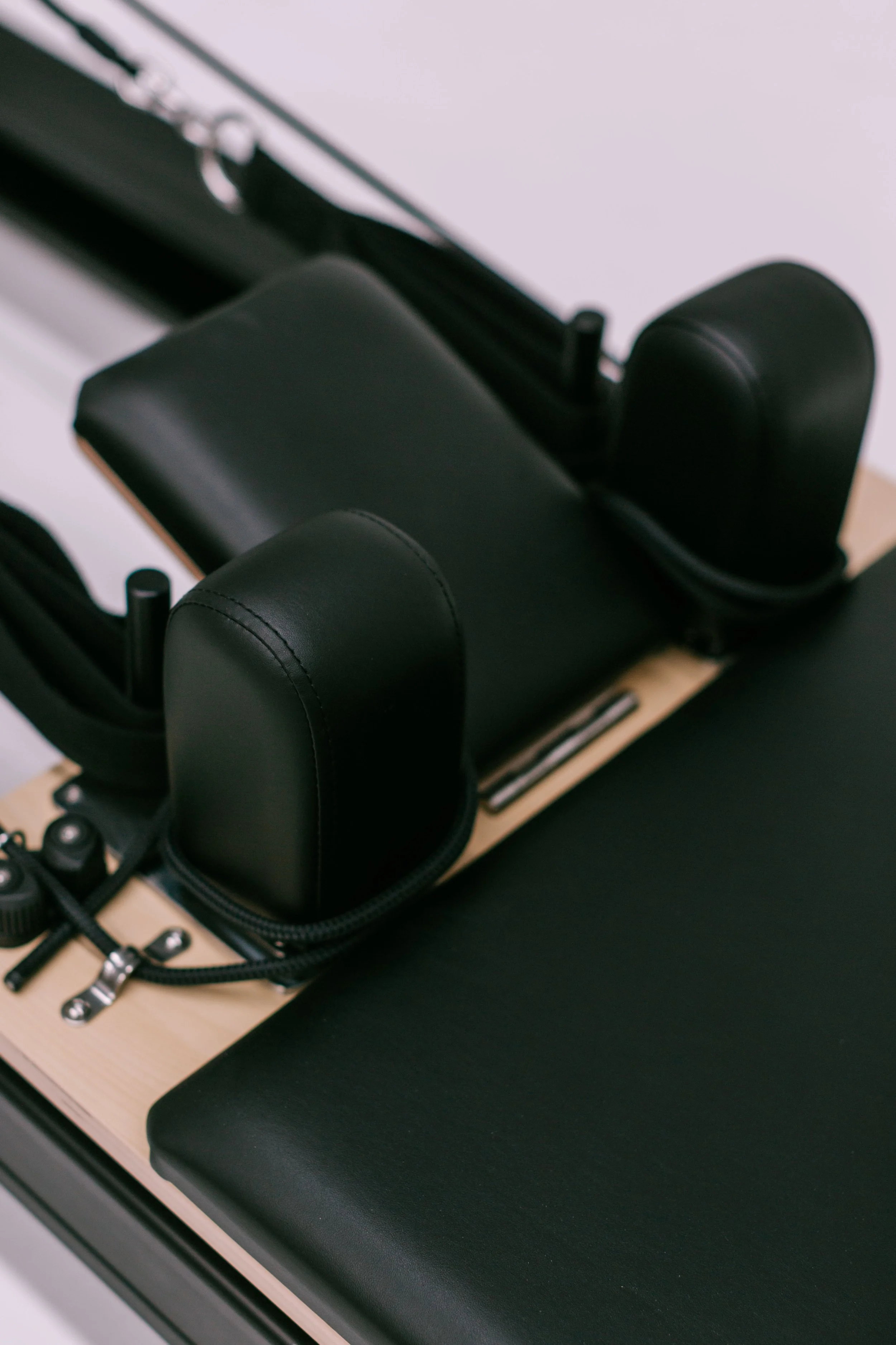 Photograph of the headrest and shoulder blocks on the luxury reformer used during the group reformer pilates classes at Worth It: A Reformer Pilates Studio located in Keller Texas, near Dallas, Texas and Fort Worth, Texas. The studio houses 12 luxury