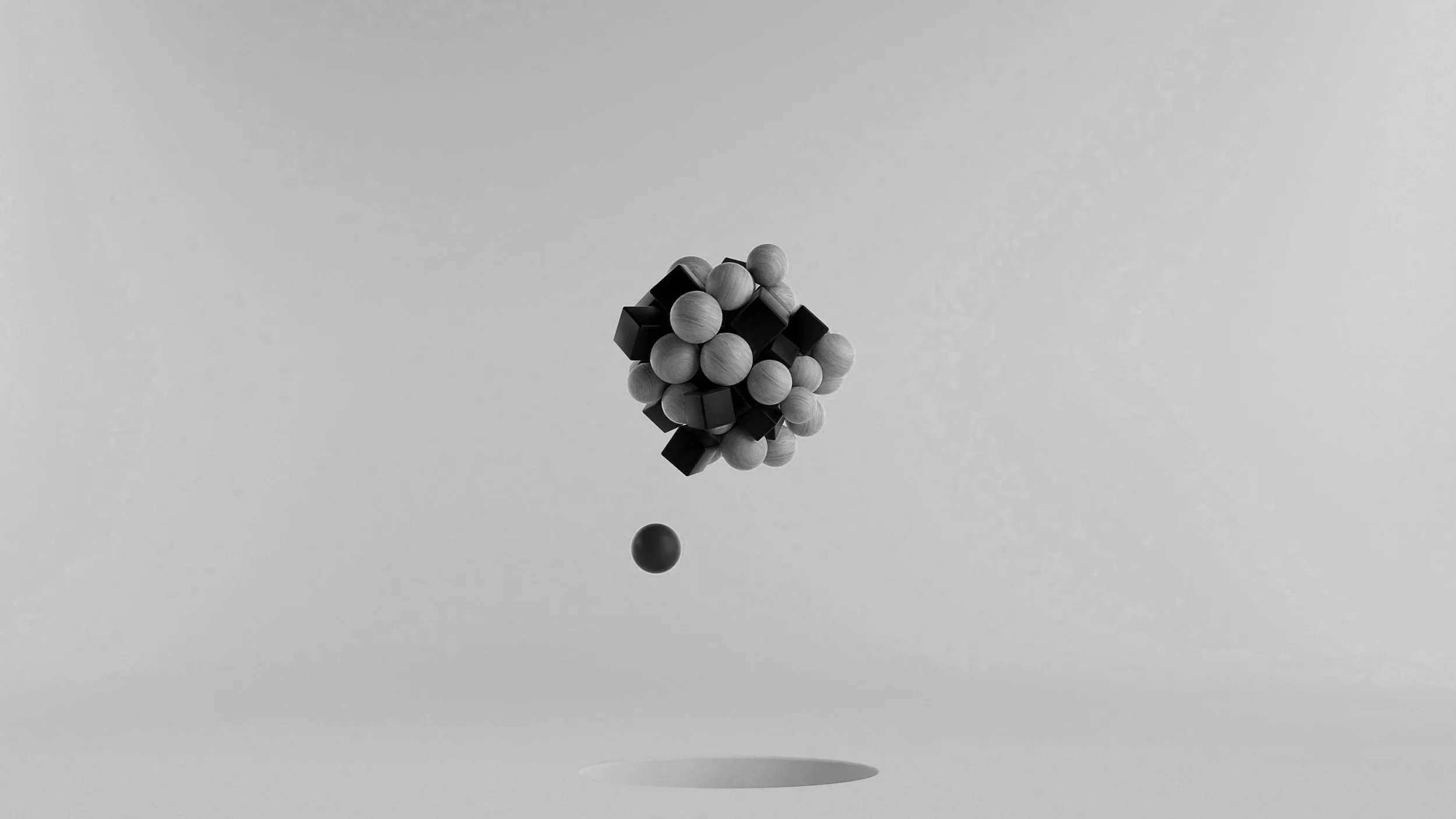 Abstract sculpture of wooden and black geometric shapes floating with shadow below on plain background.