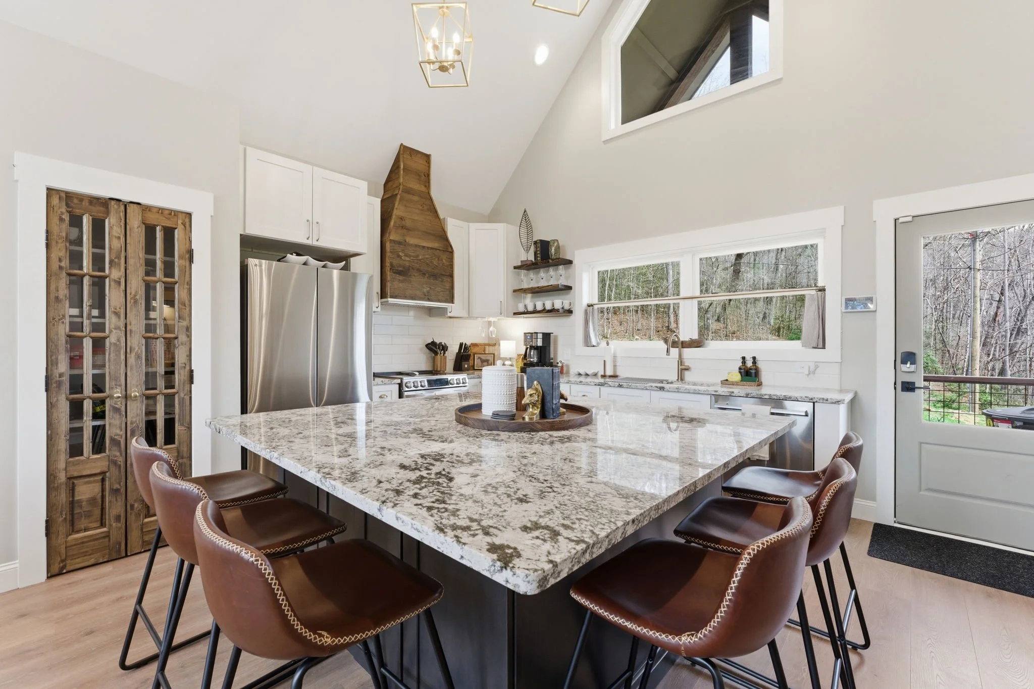 Modern Kitchen with Shaker cabinets, large island and custom range hood. 