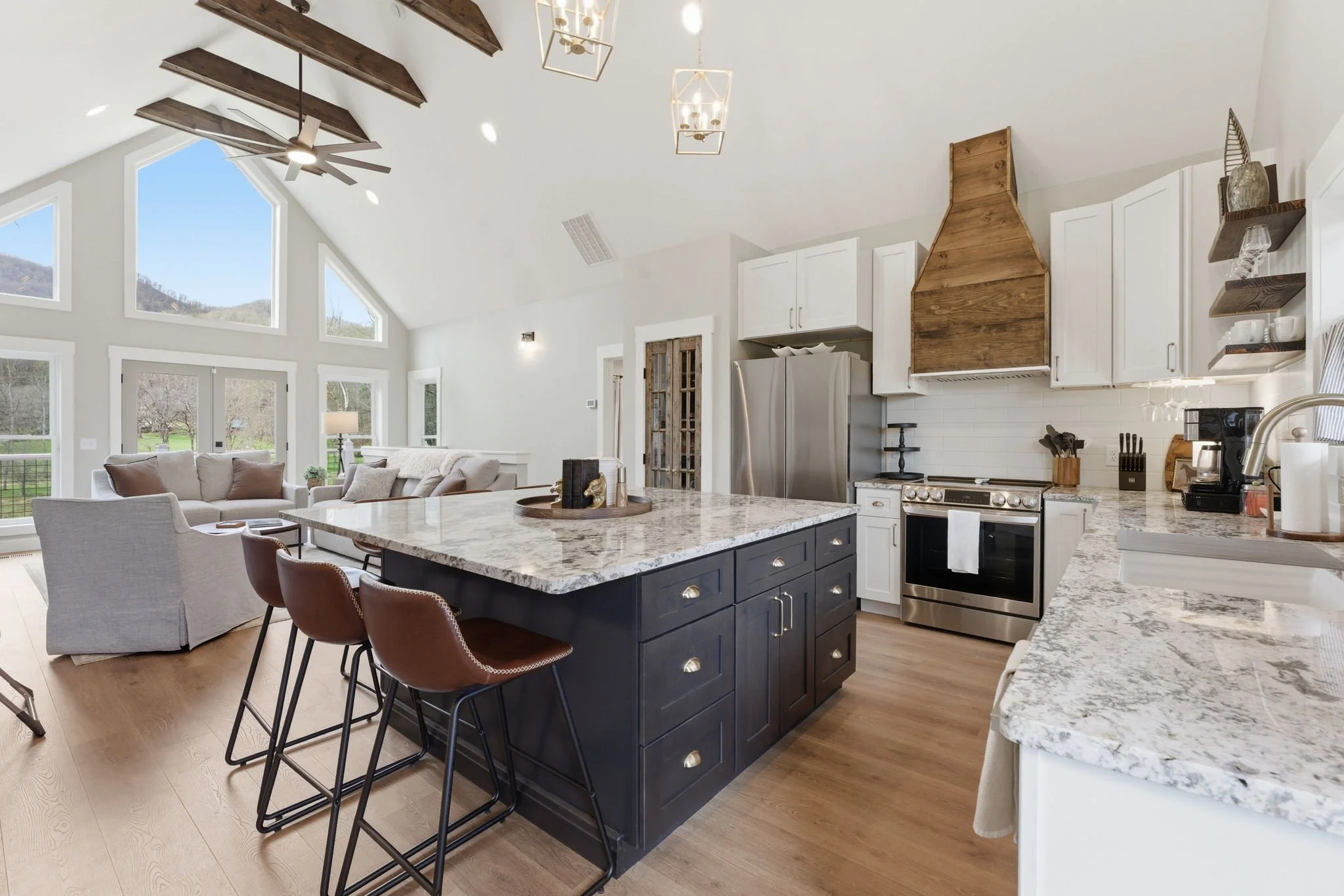 Open living, dining room,  and kitchen at this modern mountain house. 