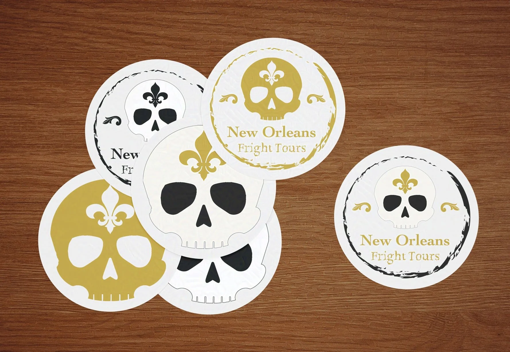 Six skull-themed "New Orleans Fright Tours" stickers overlap on a wooden surface, featuring gold fleur-de-lis accents and a spooky design.