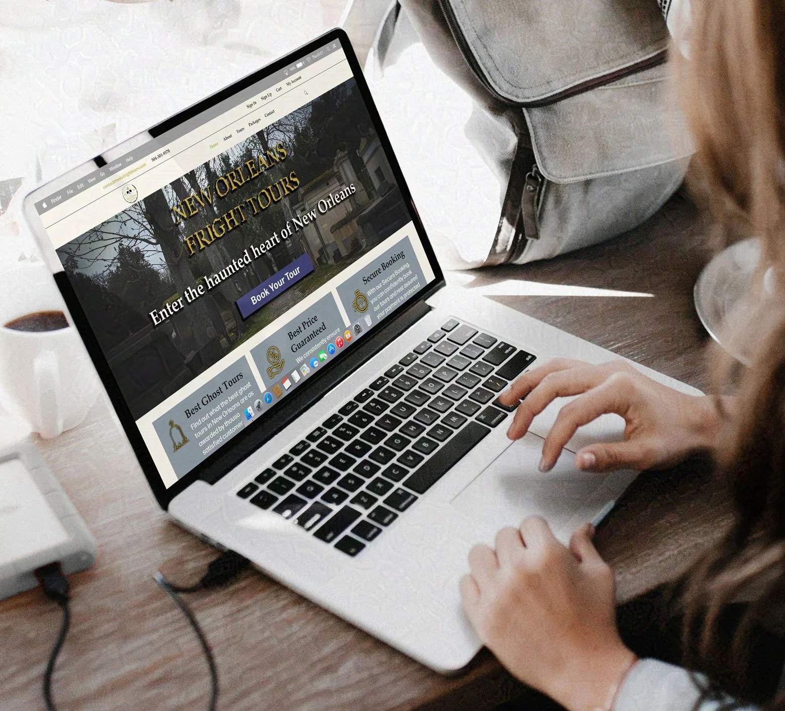 Person browses a laptop website advertising the New Orleans Fright Tours ghost tour business.