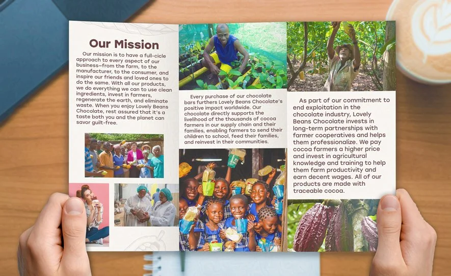 A person holds a tri-fold brochure detailing a chocolate company's mission, including images of cocoa farms, workers, and children, with text about ethical sourcing and community impact.