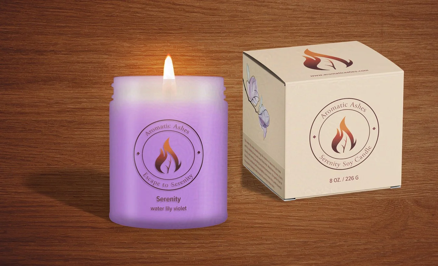 A lavender-colored candle labeled "Serenity water lily violet" with a lit flame is next to a matching box, set on a wooden surface, creating a calming ambiance.