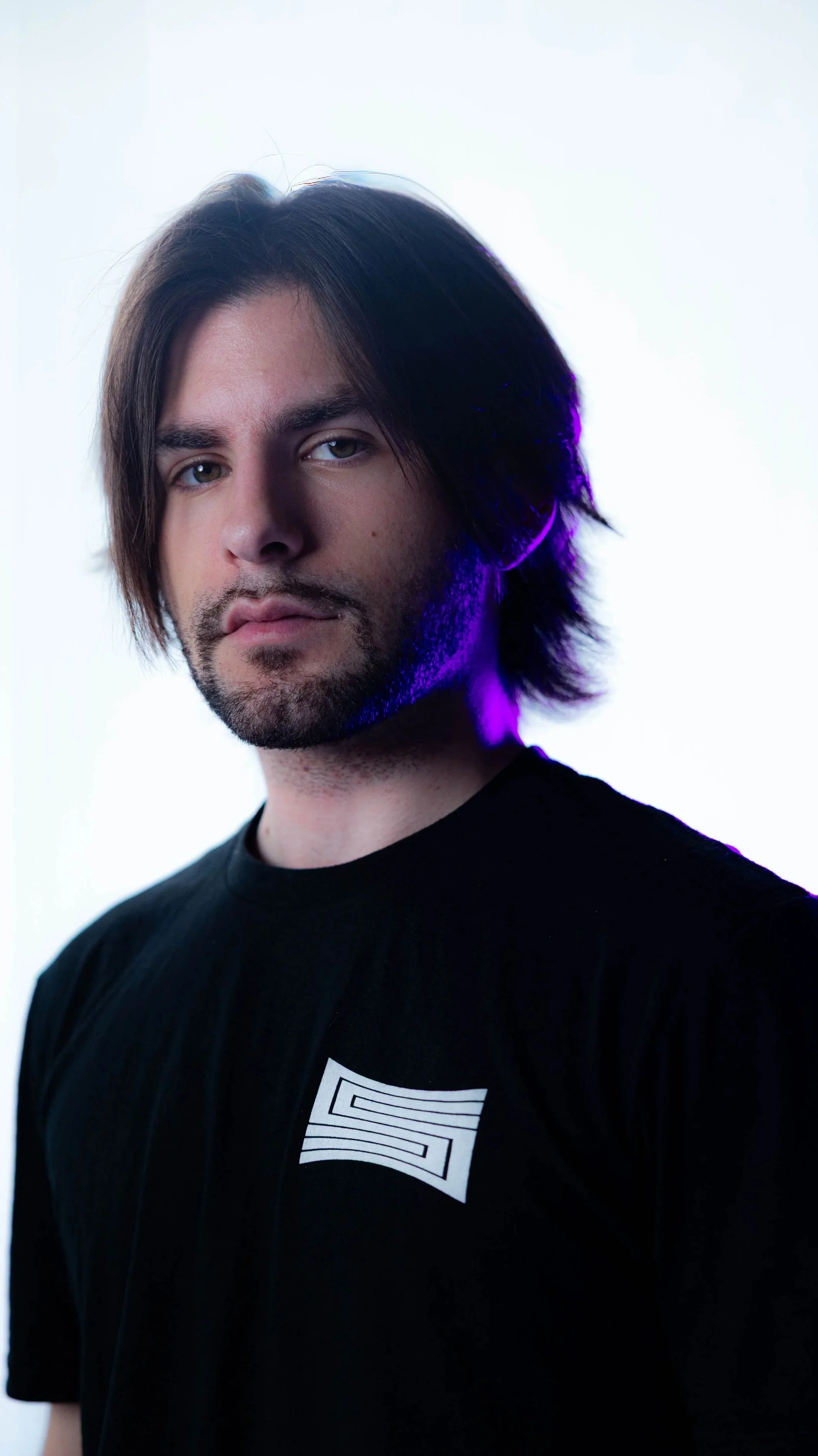 Director of Photography, Jacob Pointer, wearing a SHOTCALLER shirt against a white background with lighting effects.