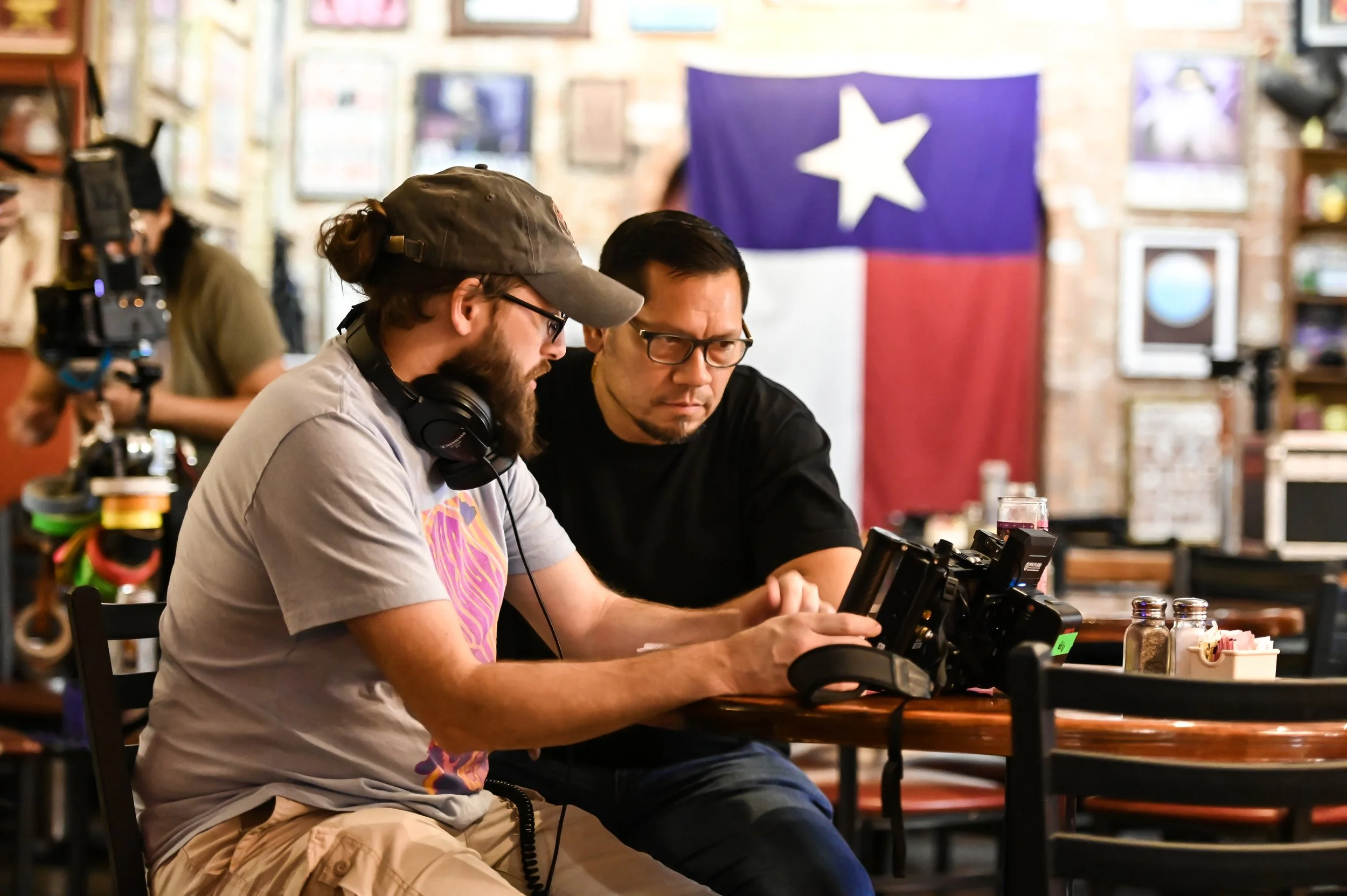 'Tonic' movie Producer Jason Starne and Director Derek Presley watch a handheld monitor.