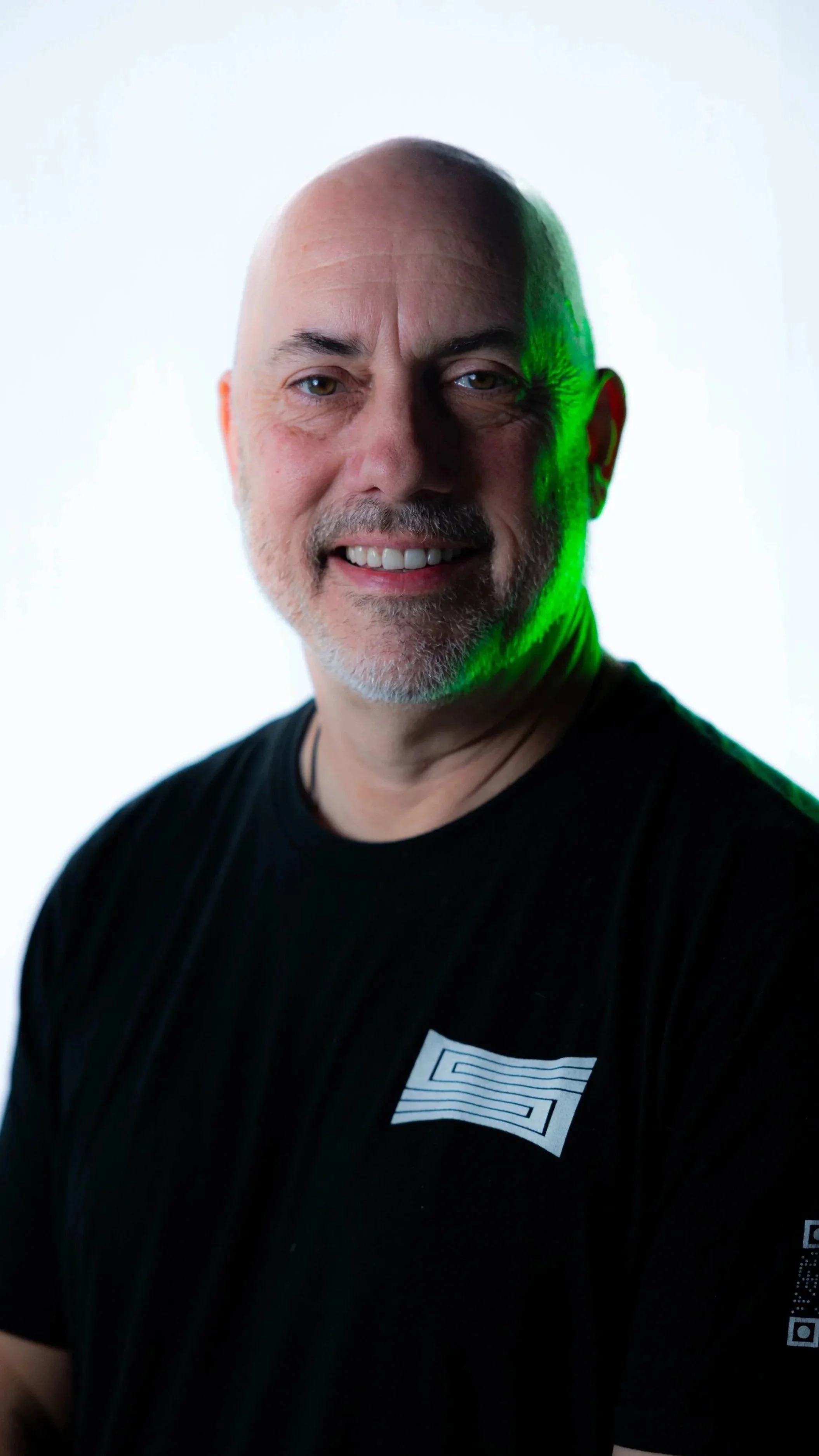 Partner and Producer, Mike Wylie, wearing a SHOTCALLER shirt against a white background with lighting effects