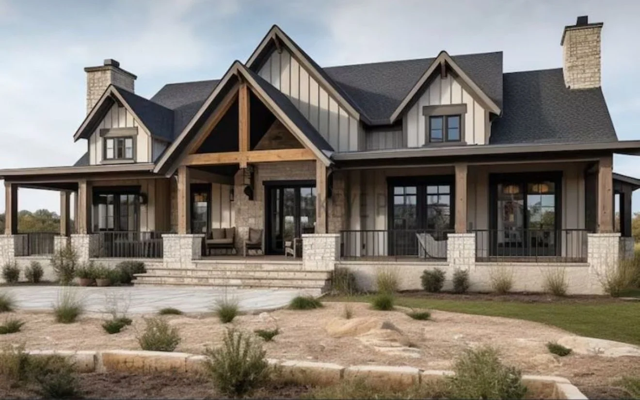 Exterior of a modern house with a large porch, stone steps, and a landscaped yard with small shrubs and rocks.