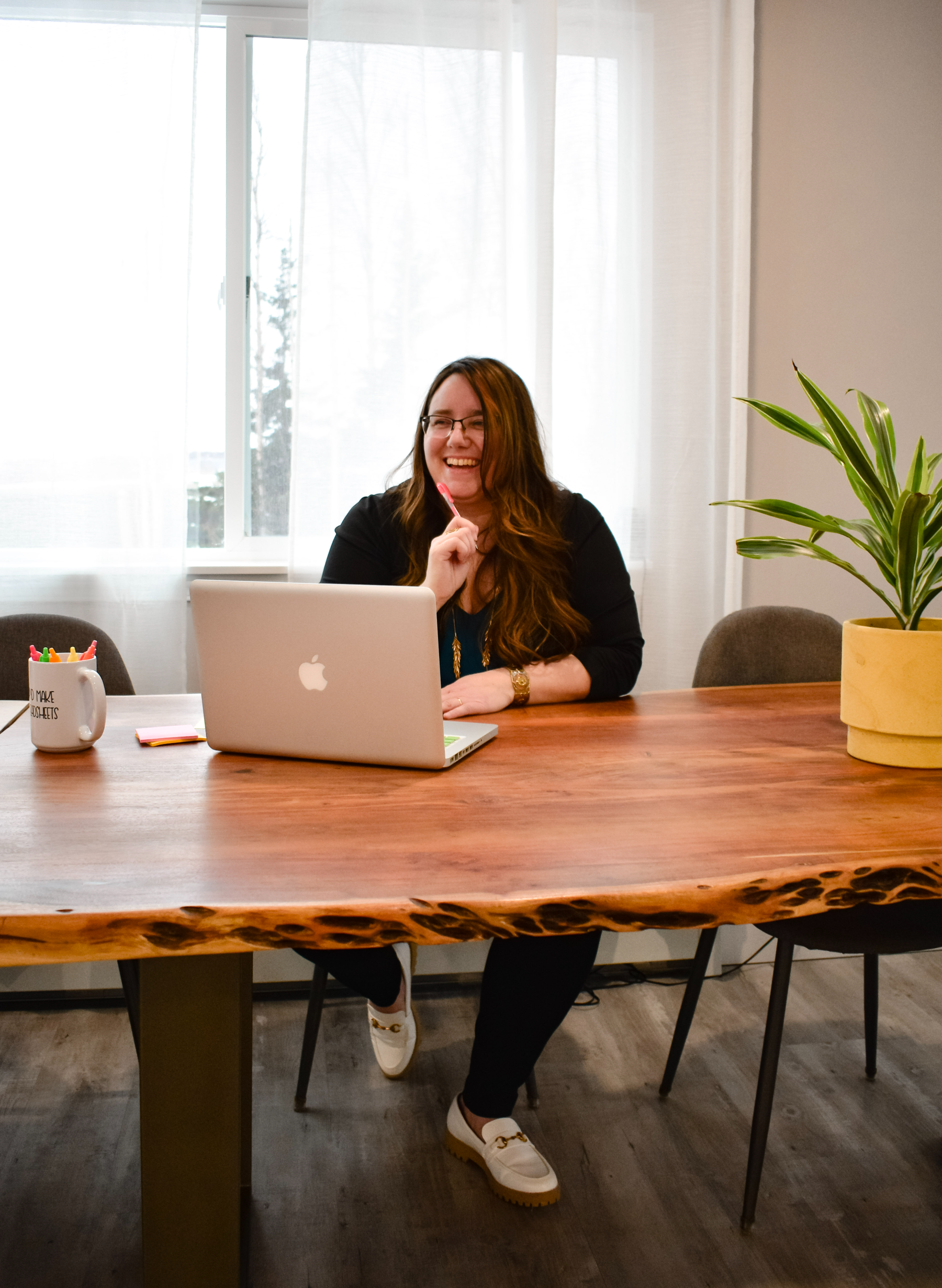 Robin Angaiak of Line and Ledger laughing at design with her lap top