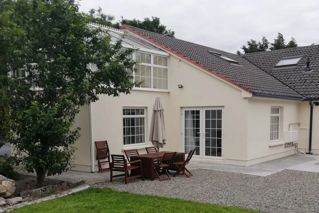 Butterfly Lodge exterior with patio seating and garden, self-catering accommodation at Kilbeg Pier, Lough Corrib, County Galway