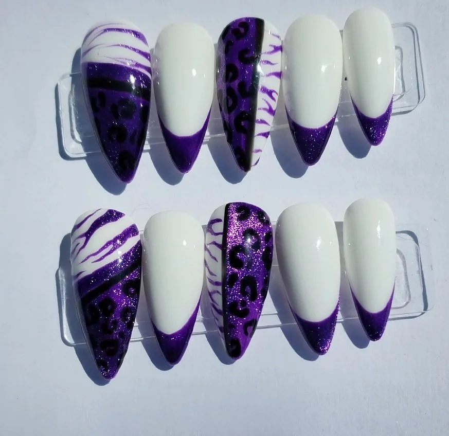 Nail art samples with purple, black, and white designs including animal print and zebra patterns on artificial nails.