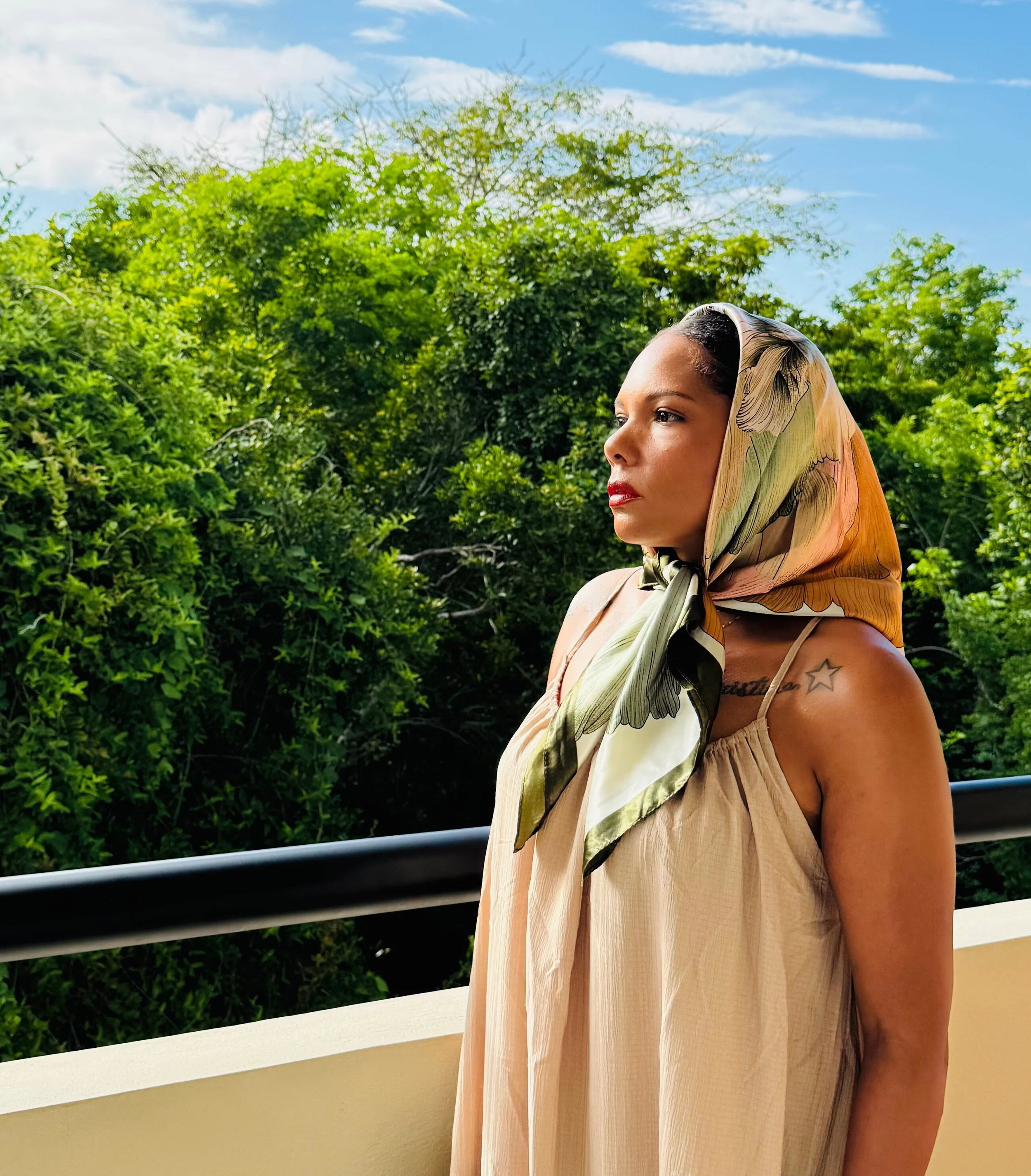 Alicia, creator of The Balanced Glow lifestyle blog, standing outdoors in a soft neutral outfit