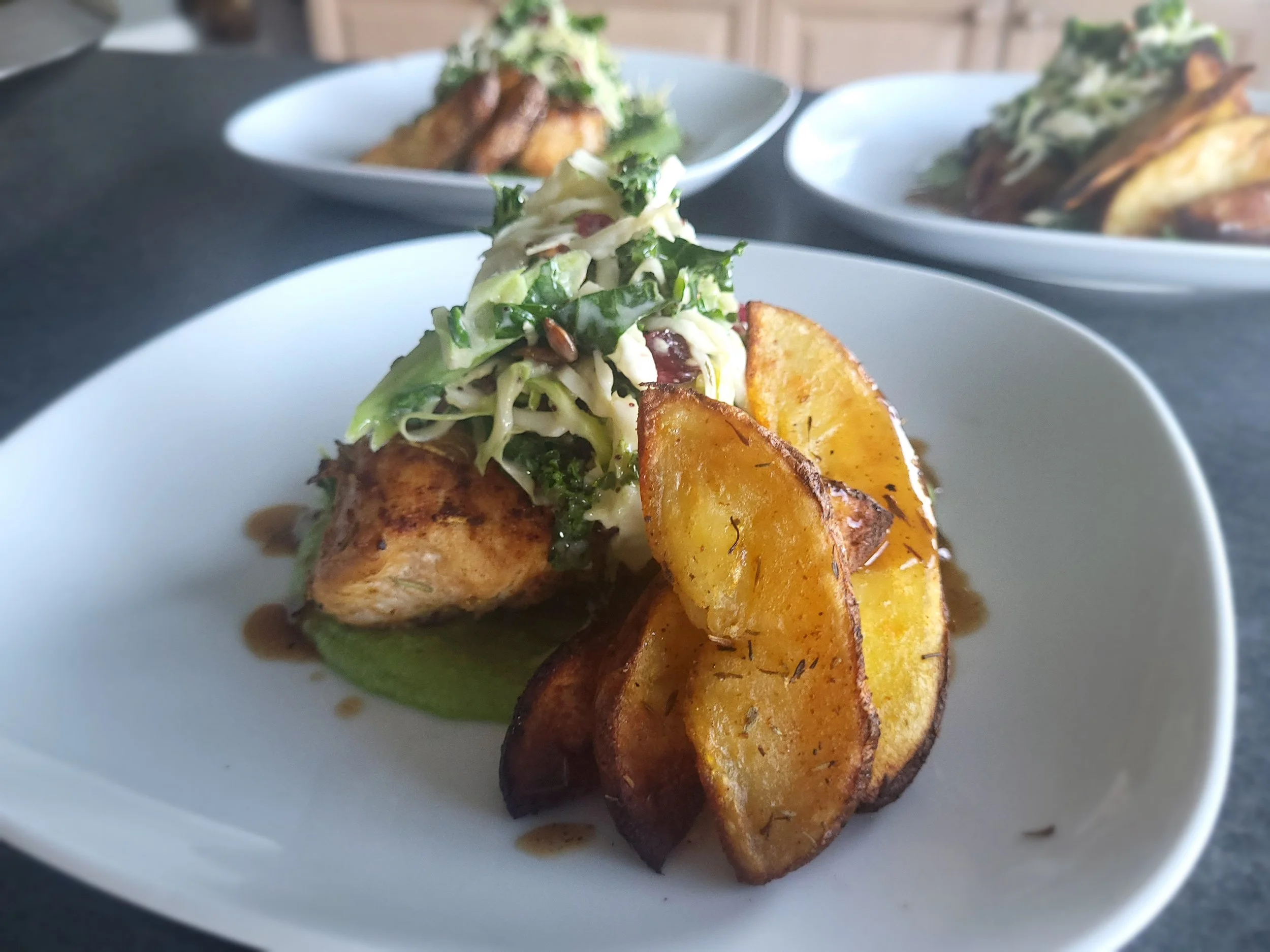 Pan- seared chicken breast w/ broccoli puree, oven roasted potato wedges & brussel sprout slaw