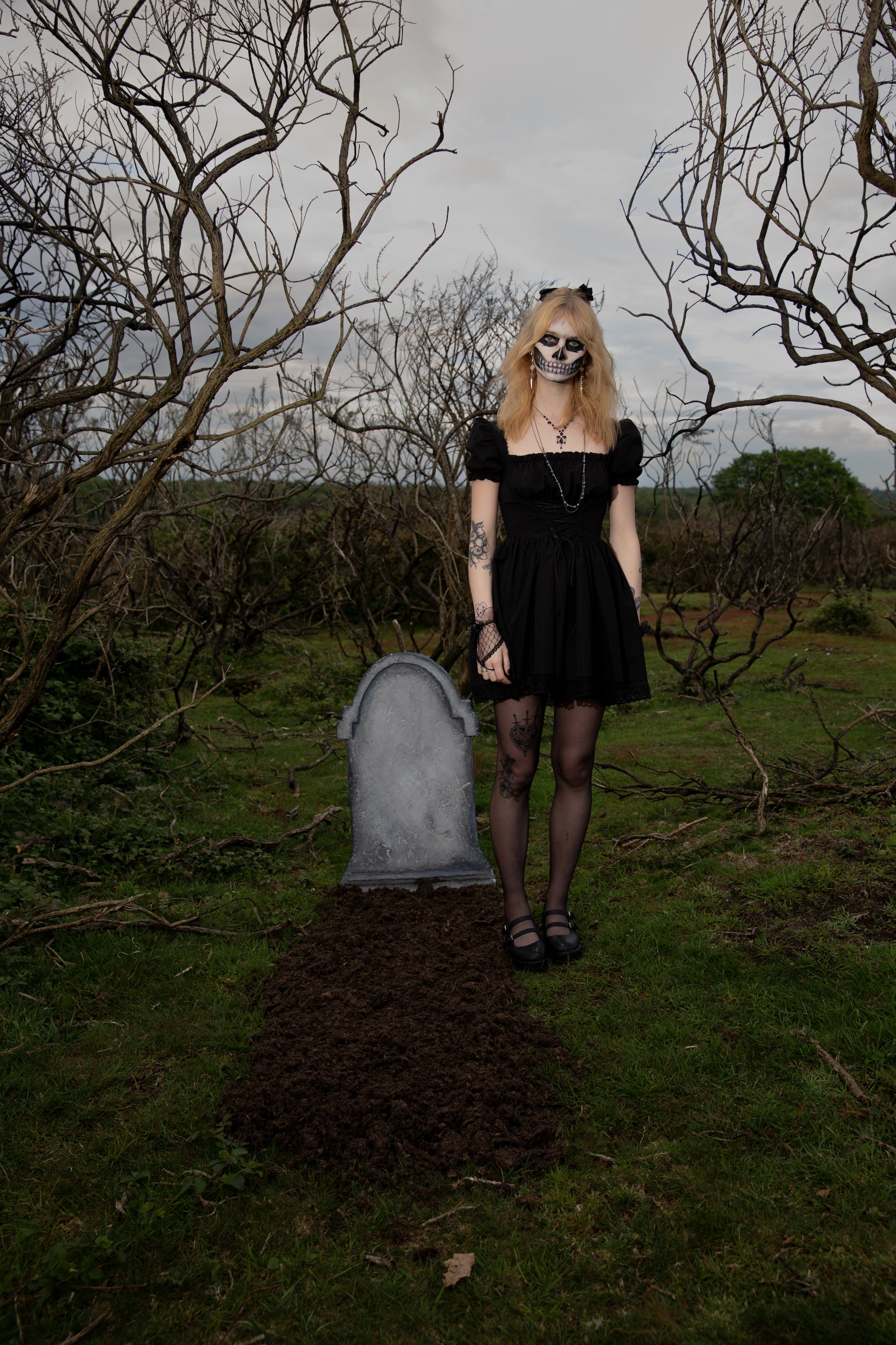 Surreal Photography including a woman in skeletal makeup around a grave. Fashion Editorial Style