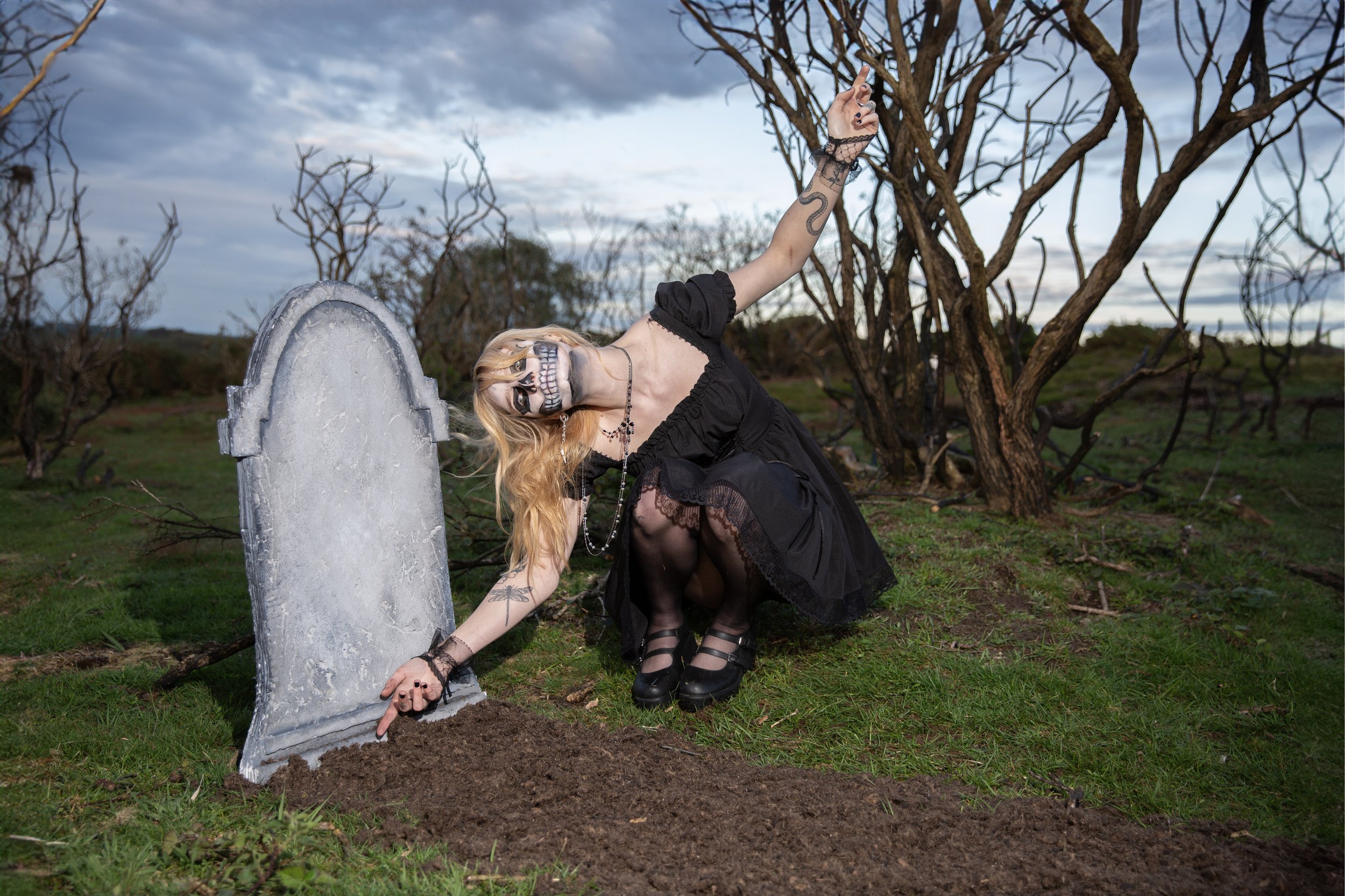 Surreal Photography including a woman in skeletal makeup around a grave. Fashion Editorial Style