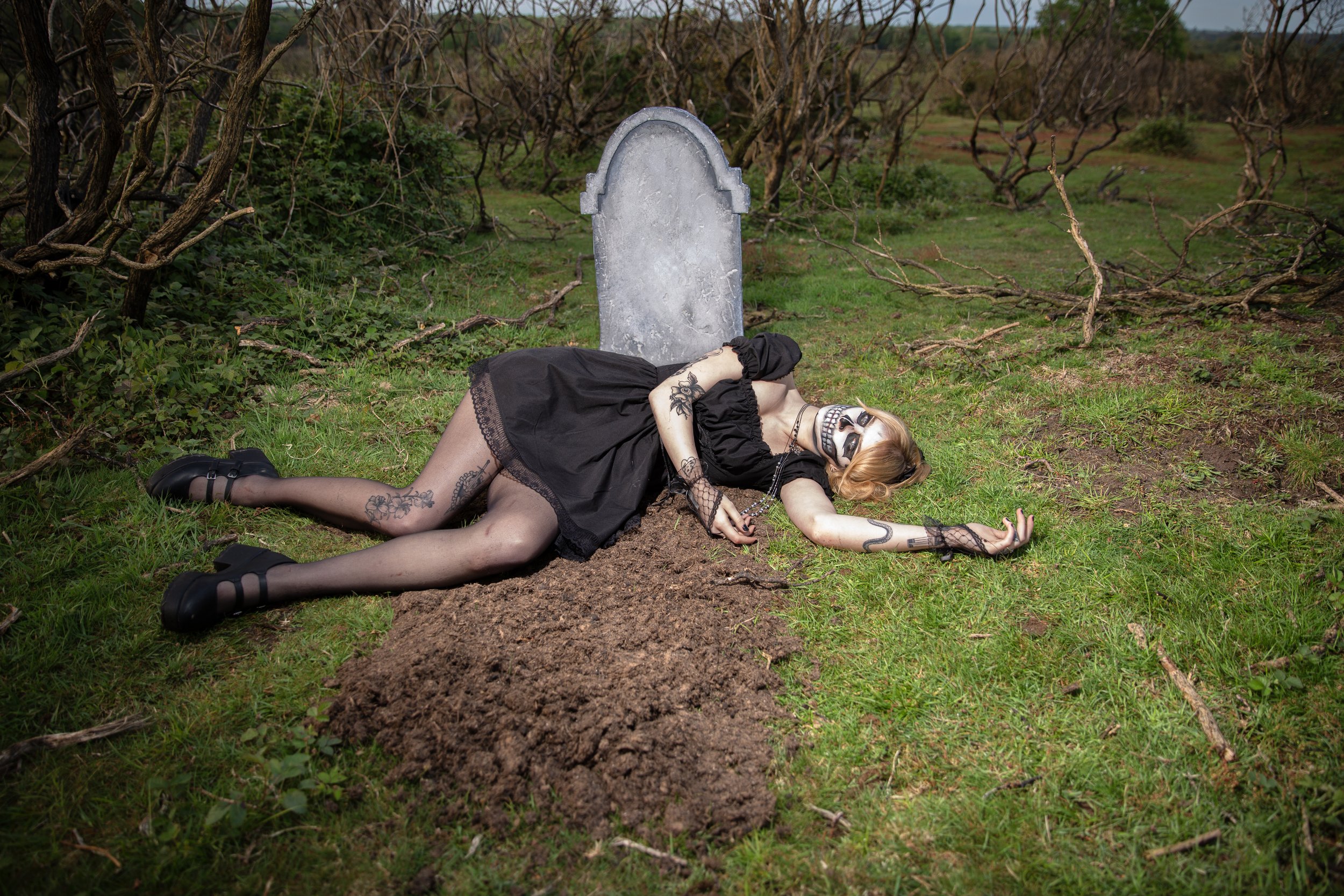 Surreal Photography including a woman in skeletal makeup around a grave. Fashion Editorial Style