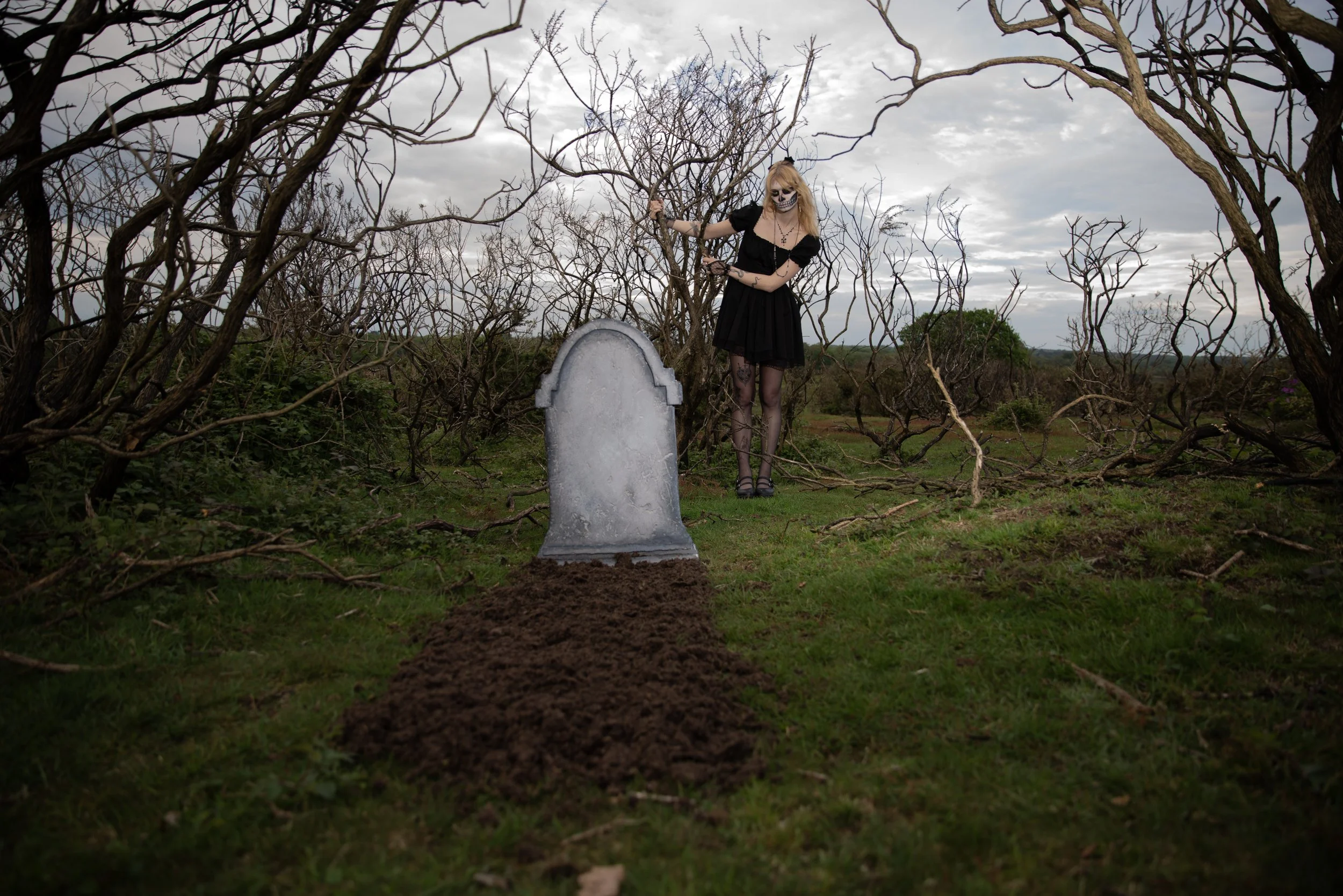 Surreal Photography including a woman in skeletal makeup around a grave. Fashion Editorial Style
