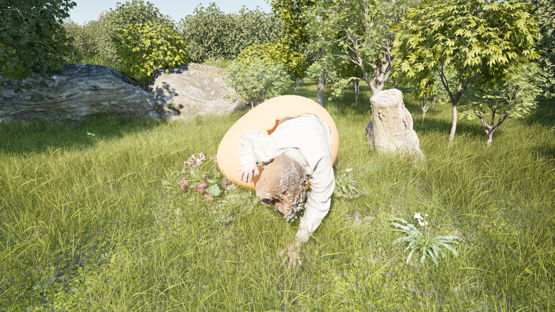 A person with curly hair wearing a beige hoodie and beige pants is bent over in a grassy field, surrounded by trees, flowers, and rocks. The person appears to be looking down at the ground.