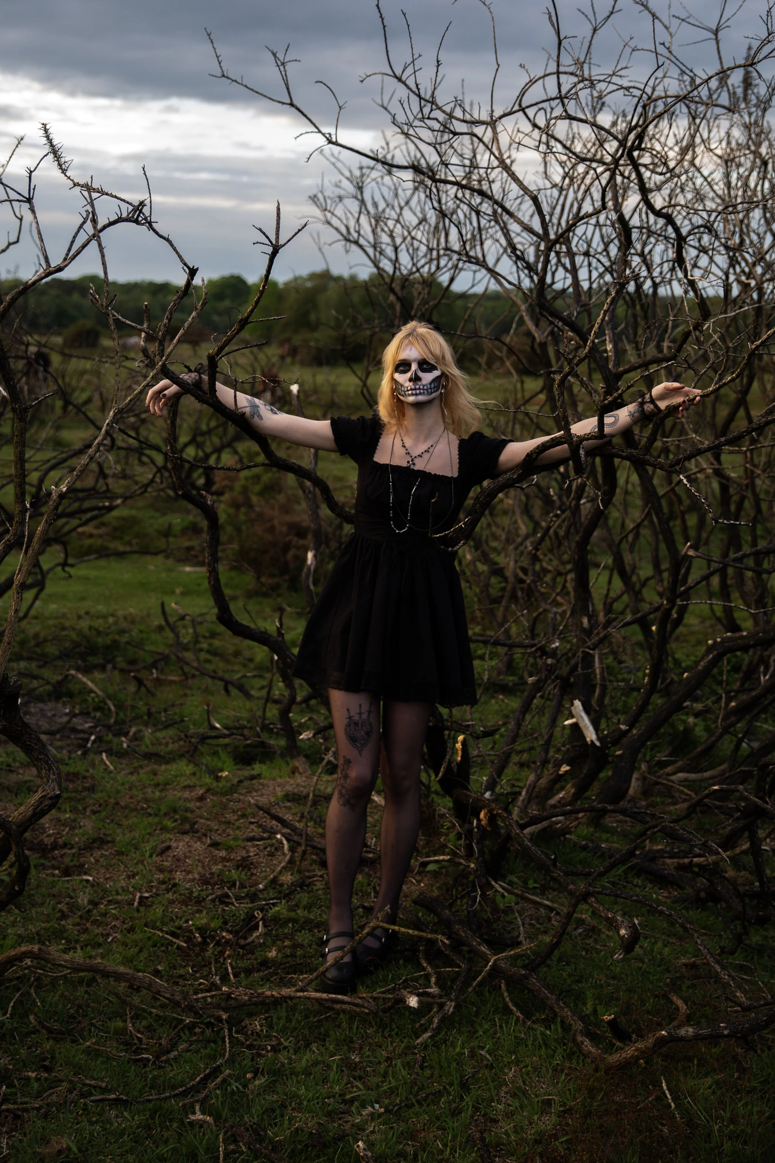 Surreal Photography including a woman in skeletal makeup around a grave. Fashion Editorial Style