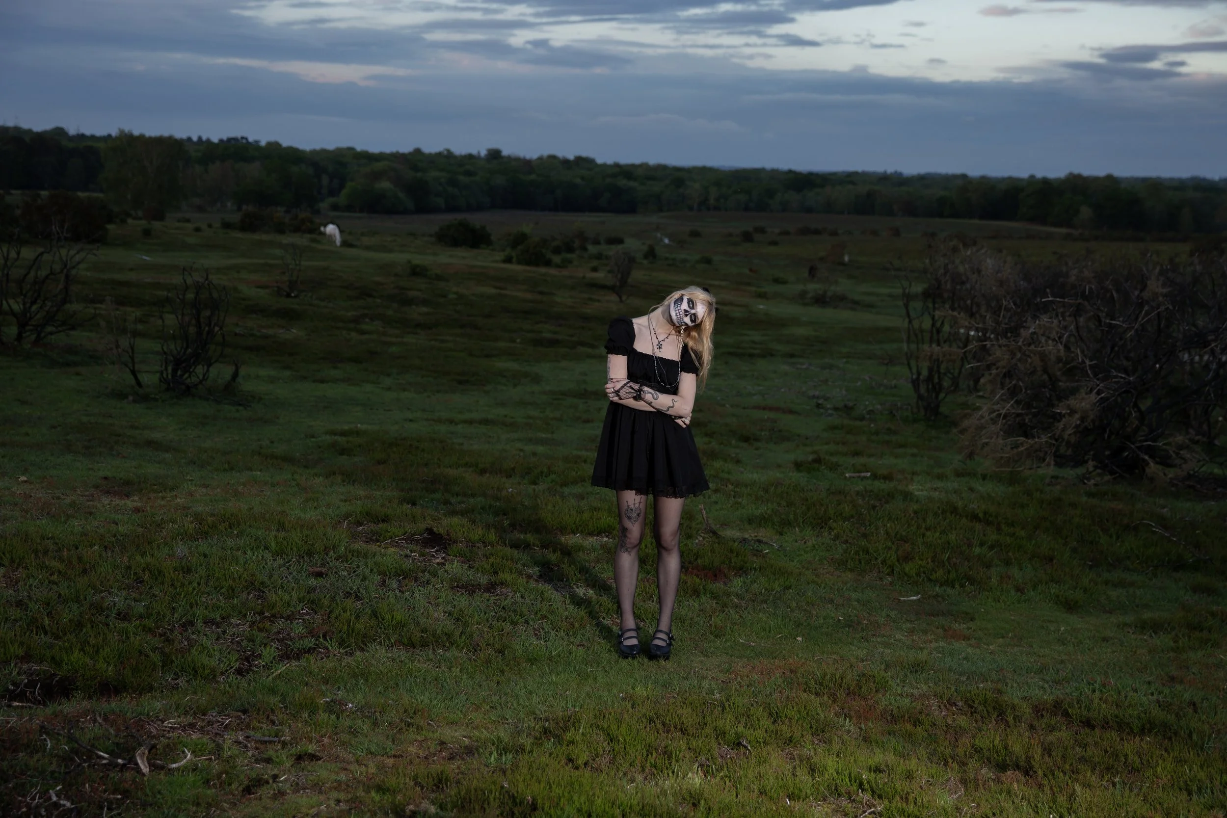 Surreal Photography including a woman in skeletal makeup around a grave. Fashion Editorial Style