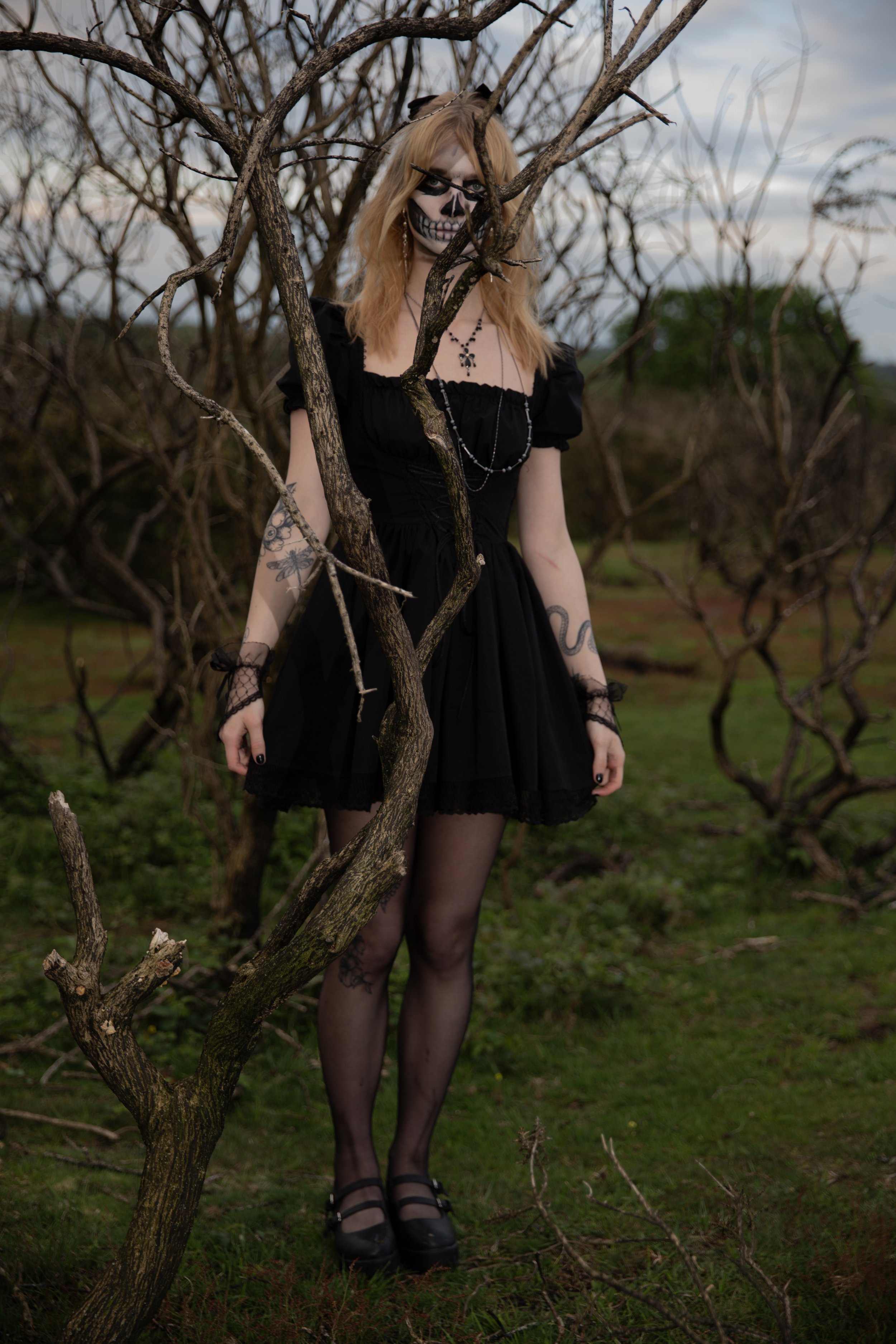 Surreal Photography including a woman in skeletal makeup around a grave. Fashion Editorial Style