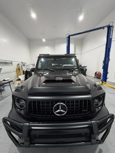 Satin Black Mercedes G63 in for body panel upgrades. 