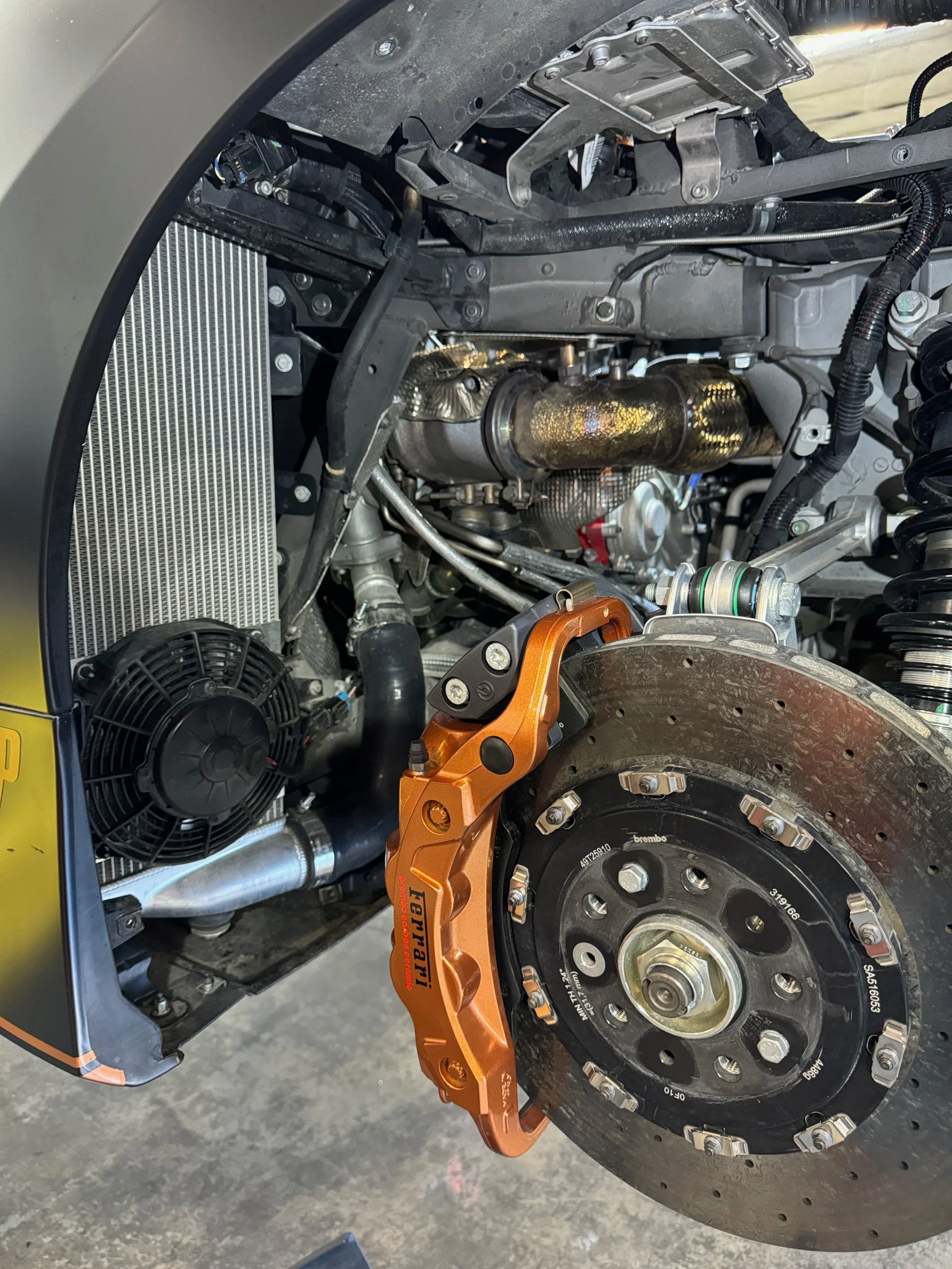 Big brake kit with orange calipers fitted to an exotic vehicle in Frisco, TX