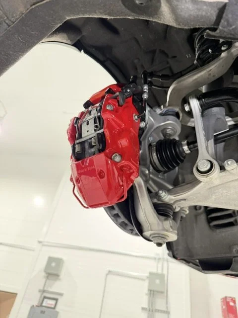 Brake calipers freshly painted from yellow to red. 