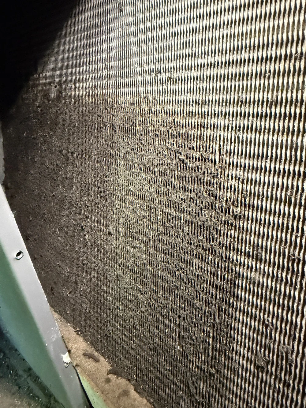 Visible buildup across the fins of an HVAC coil.