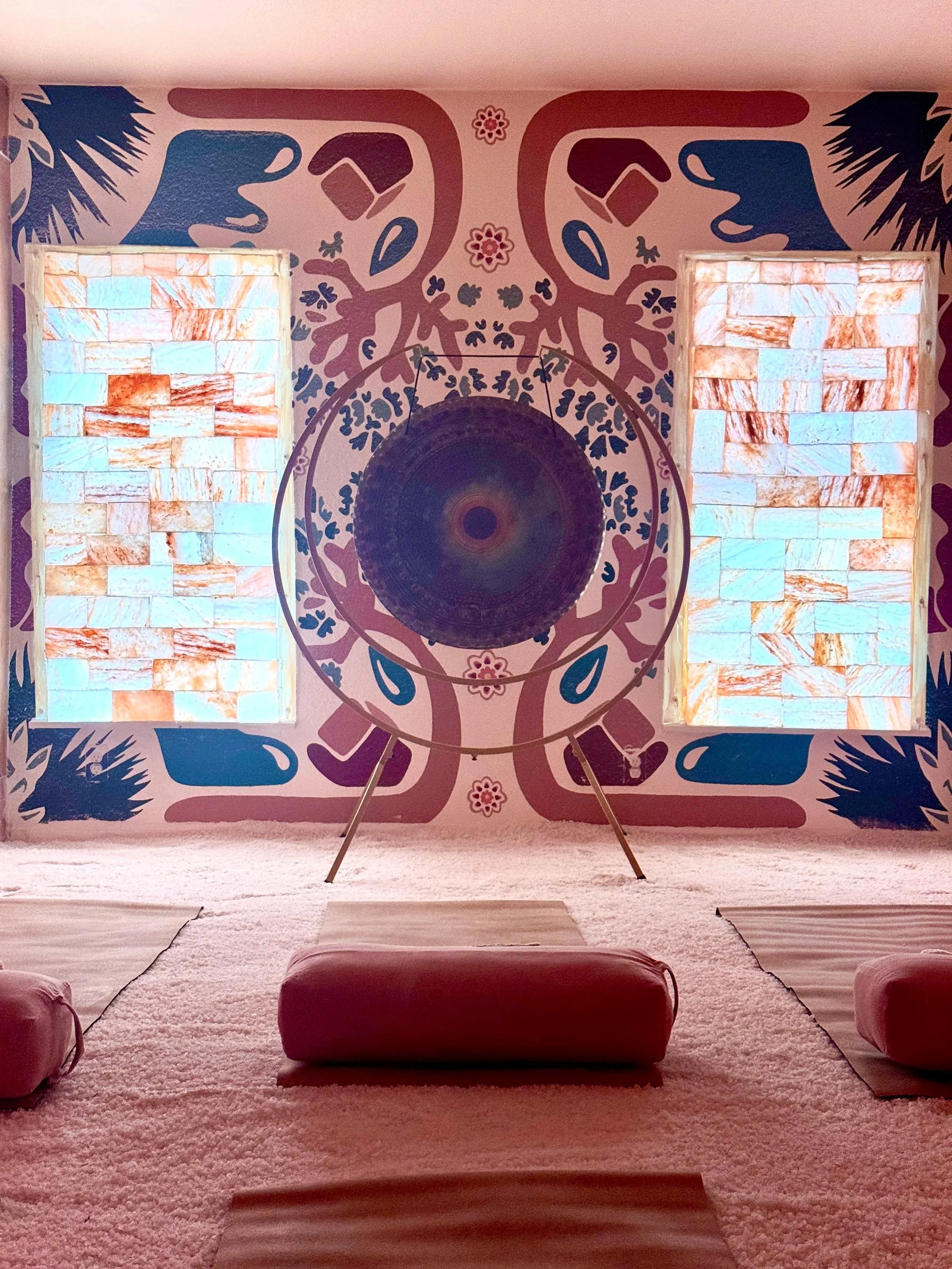Restorative yoga and sound healing setup inside a Himalayan salt therapy room