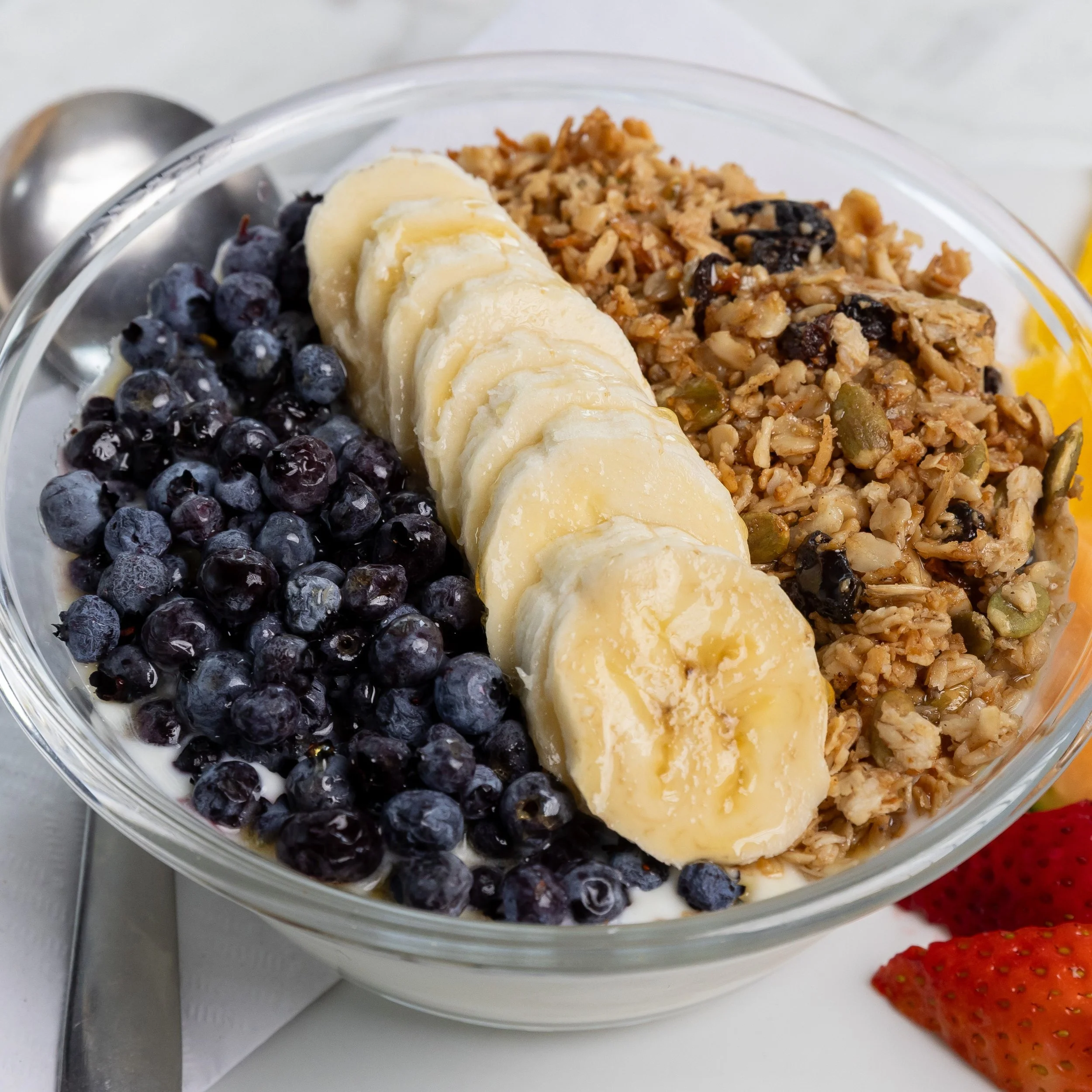 Bowl of yogurt and granola with berries and bananas At Fancy Pants Cafe in Bridgewater, Nova Scotia