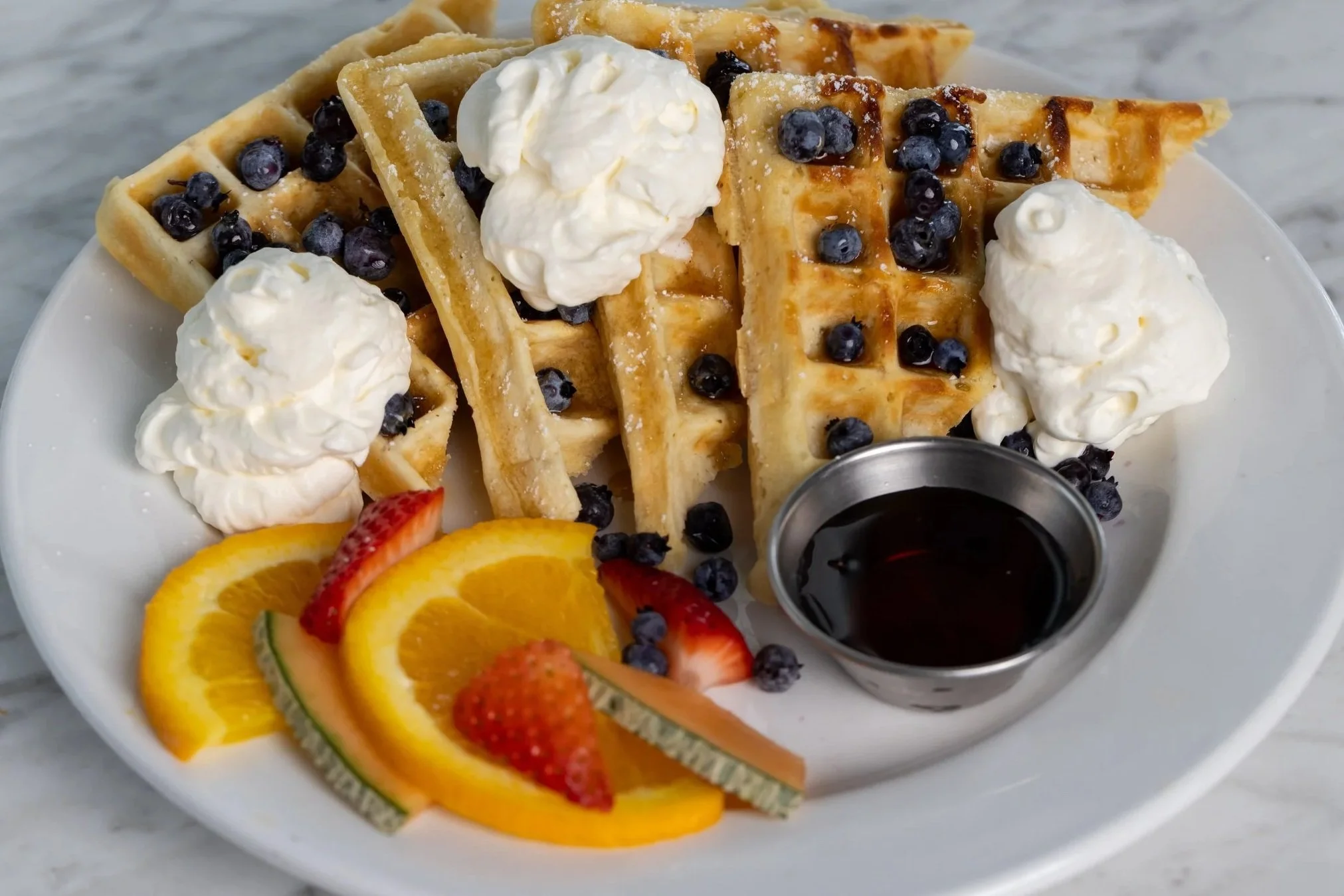 Waffles with blueberries and whipped cream At Fancy Pants Cafe in Bridgewater, Nova Scotia