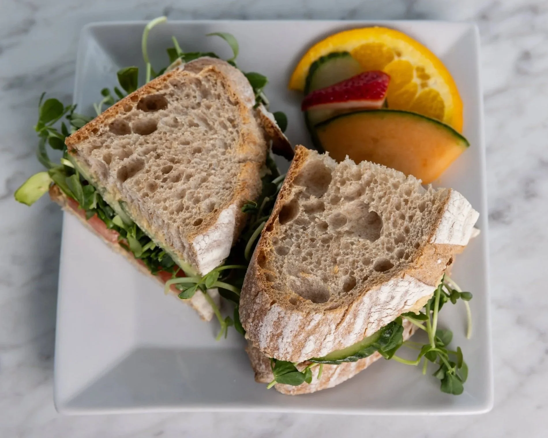 Turkey sandwich with side of fresh fruit At Fancy Pants Cafe in Bridgewater, Nova Scotia