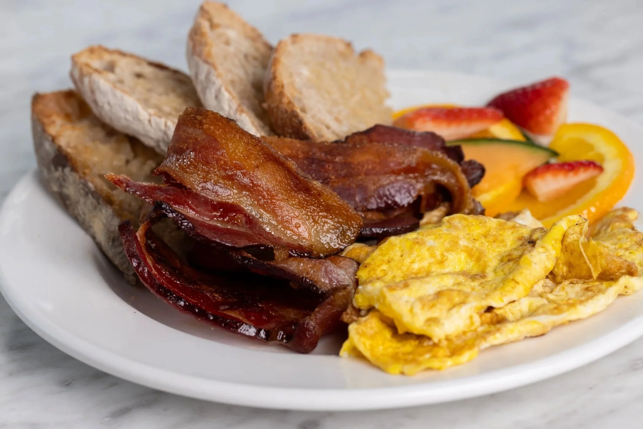 Standard breakfast with eggs, toast, bacon and fresh fruit At Fancy Pants Cafe in Bridgewater, Nova Scotia