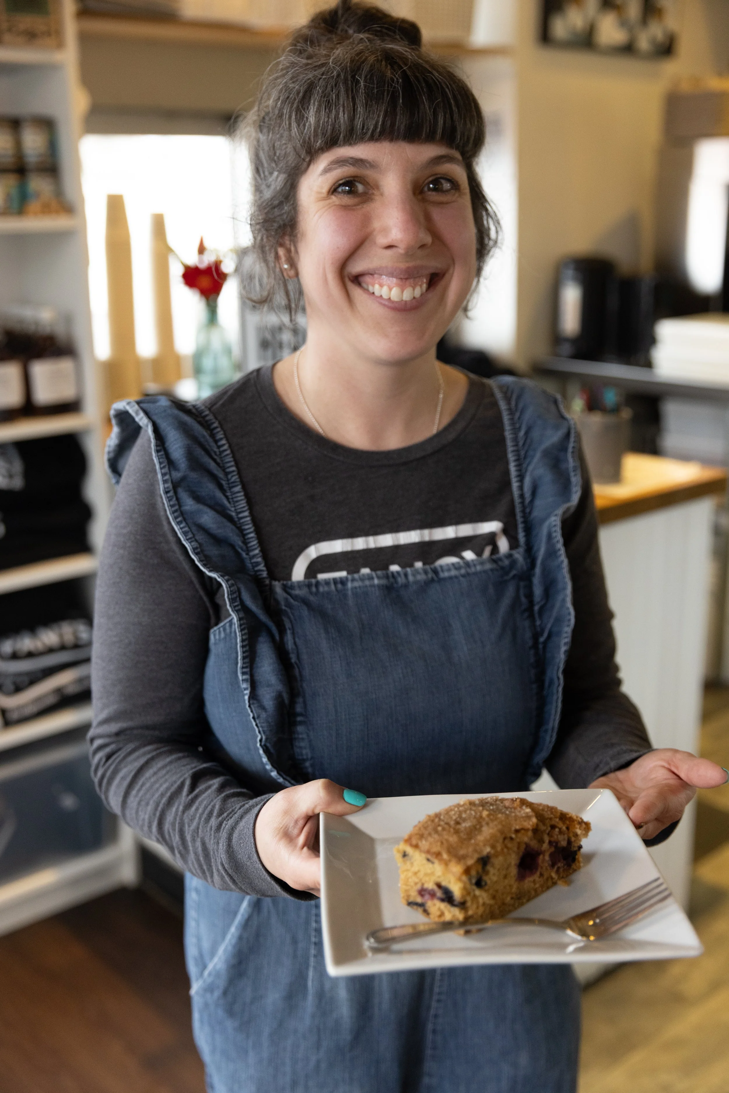 Hayley, owner of Fancy Pants Cafe in Bridgewater, Nova Scotia smiles at the camera.