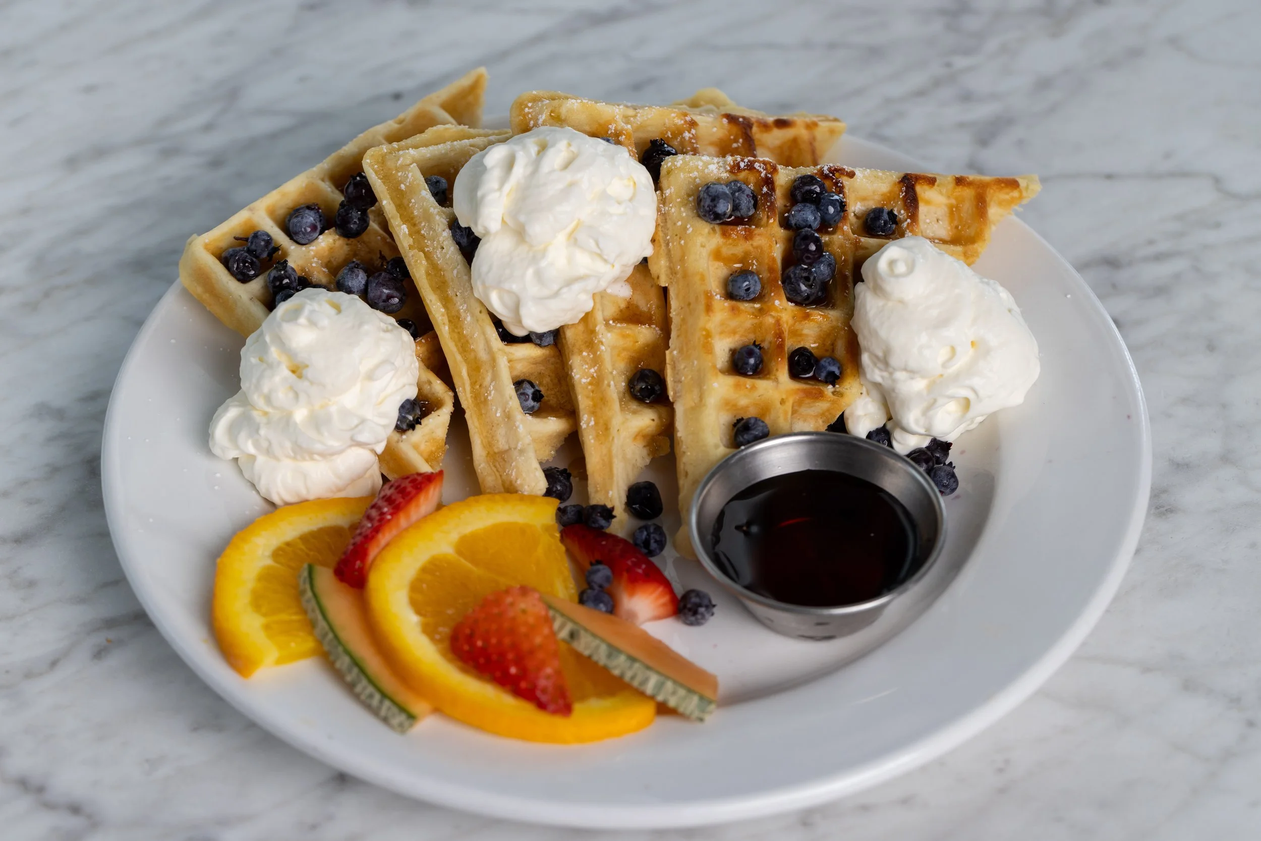 Waffles dressed with blueberries At Fancy Pants Cafe in Bridgewater, Nova Scotia