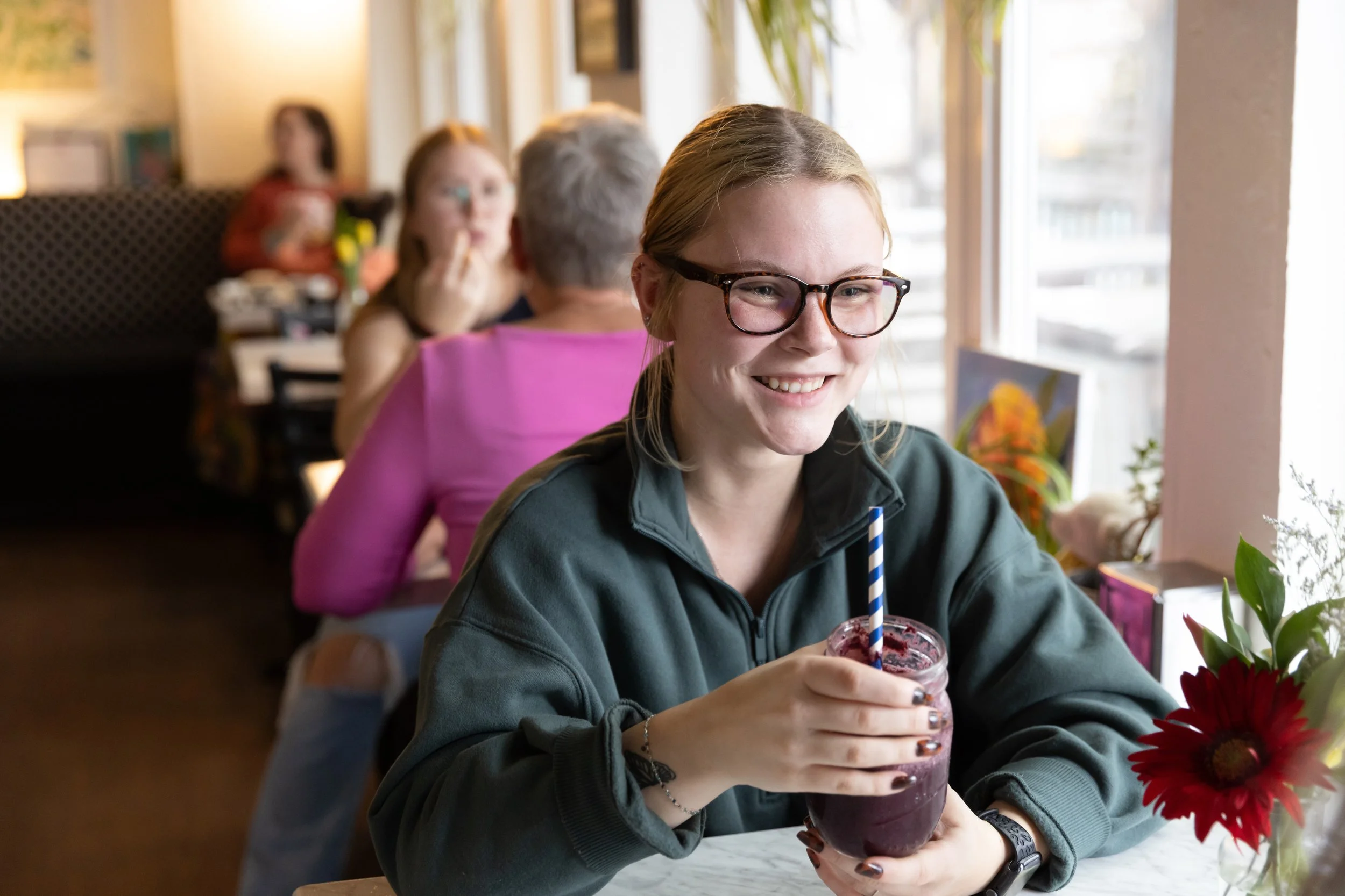 A customer enjoys a purple smoothie at Fancy Pants Cafe in Bridgewater, NS