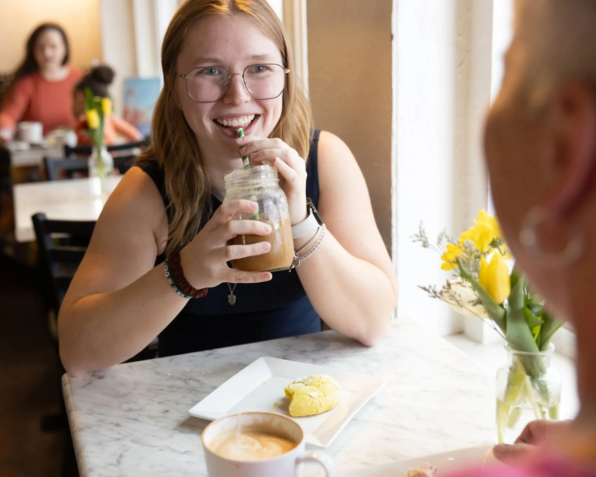 A customer enjoys her iced coffee in a mason jar at Fancy Pants Cafe in Bridgewater, NS