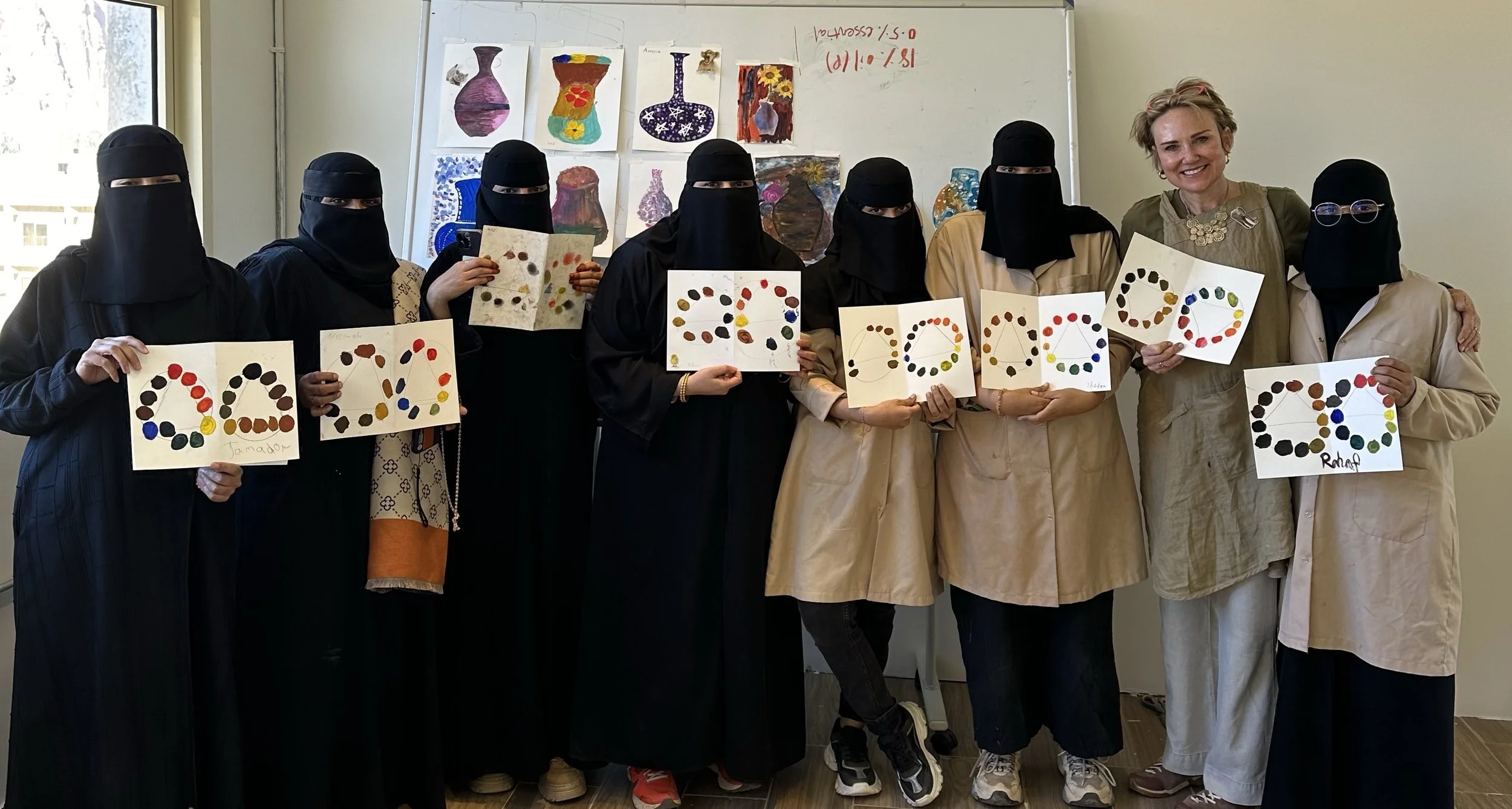 Erin McGee Ferrell and participants displaying circular color studies during a Turquoise Mountain color theory workshop in AlUla.
