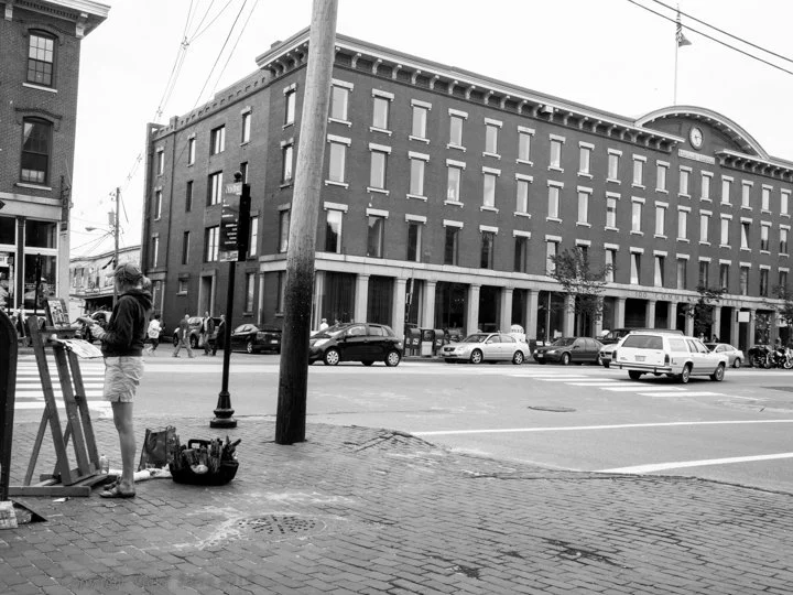 Erin McGee Ferrell painting at a street corner in Portland, Maine.