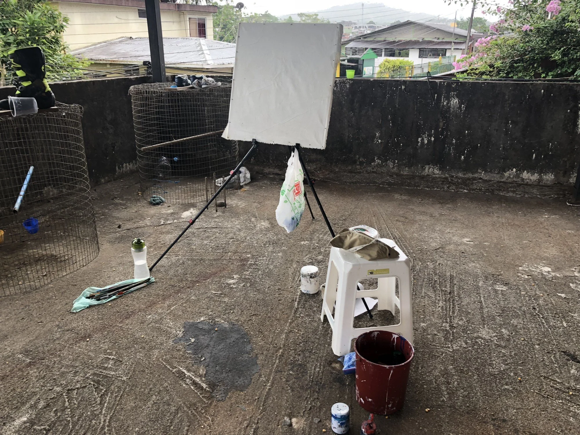 An easel, brushes, and paint containers on a rooftop in Tena, Ecuador, where Erin McGee Ferrell worked.