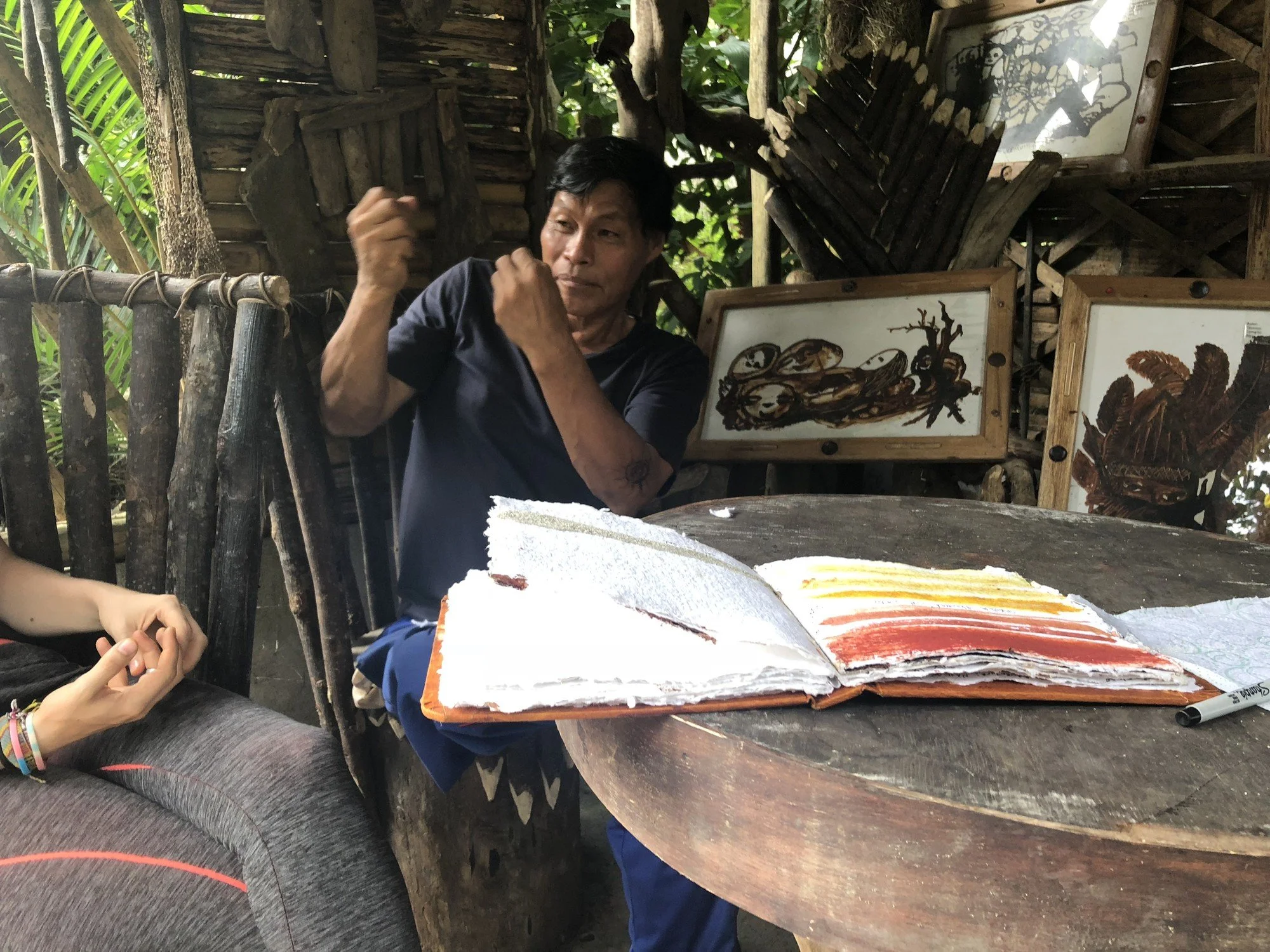 Elías Mamallacta Alvarado, a Kichwa painter using ancestral traditions and natural paints and pigments from the Amazon forest, with Erin McGee Ferrell’s handmade-paper sketchbook, Ecuador, 2018. His interest in better paper helped inspire the propose
